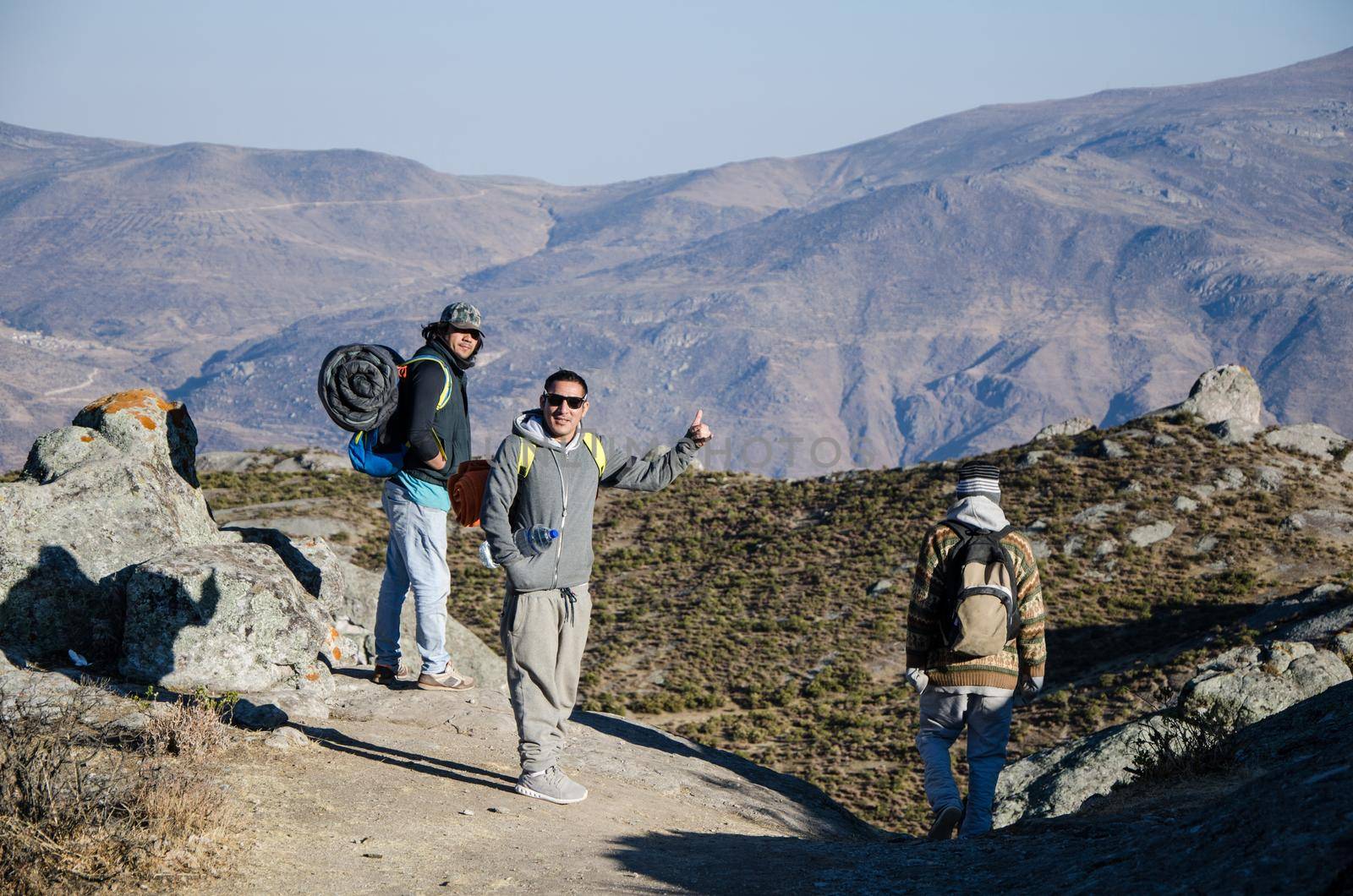 travel, tourism, hike, gesture and people concept - group of smiling friends