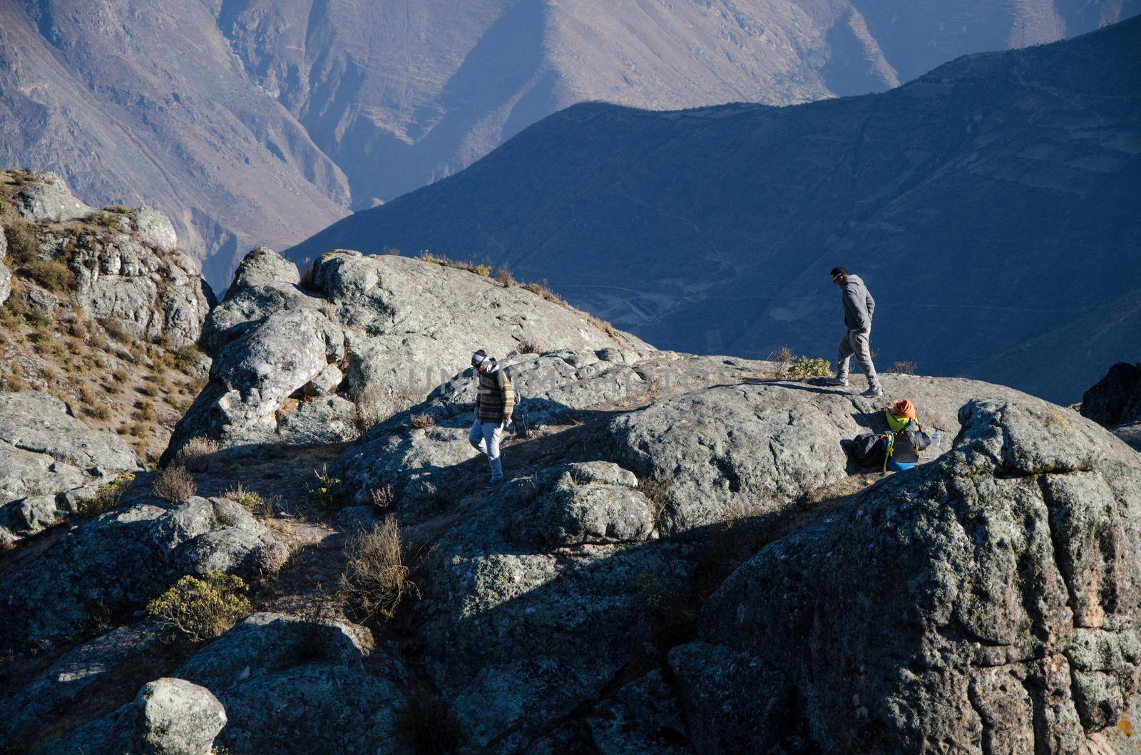 Traveling friends climbing the big rocks in Marcahuasi by Peruphotoart