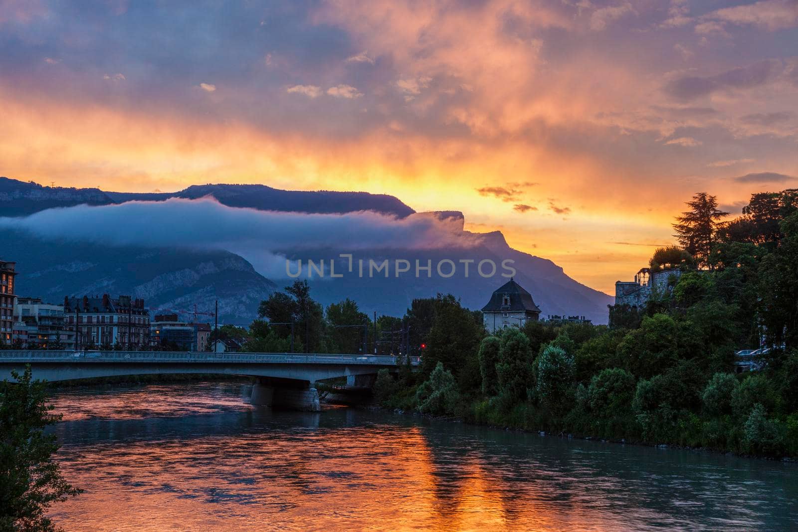 Grenoble architecture along Isere River seen at sunset. Grenoble, Auvergne-Rhone-Alpes, France.