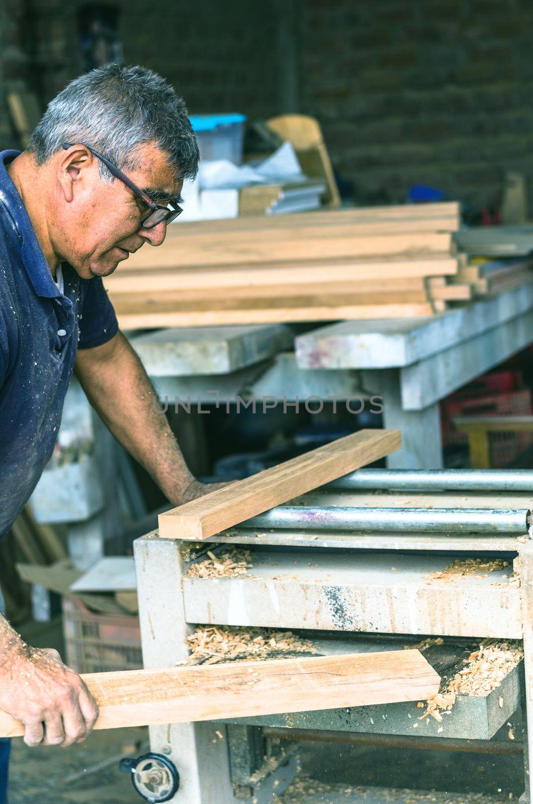 Carpenter using belt sander. Carpenter sanding a wood with belt sander
