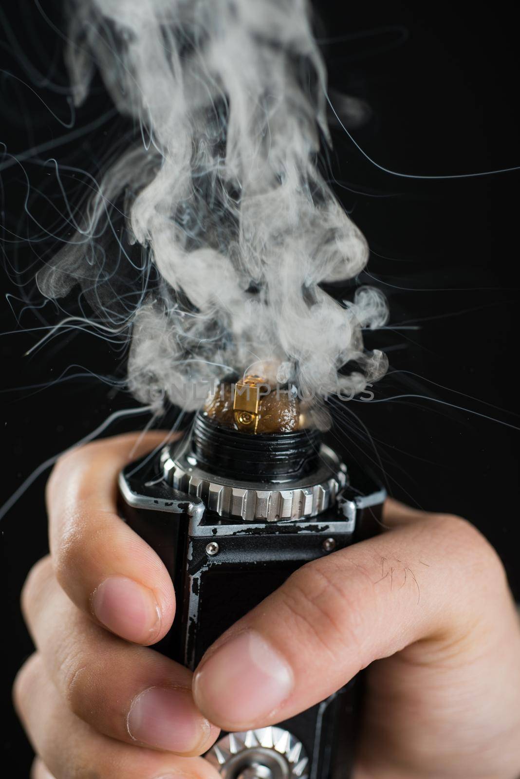 electronic cigarette mechanical mod closeup . a lot of steam . centered on a black background