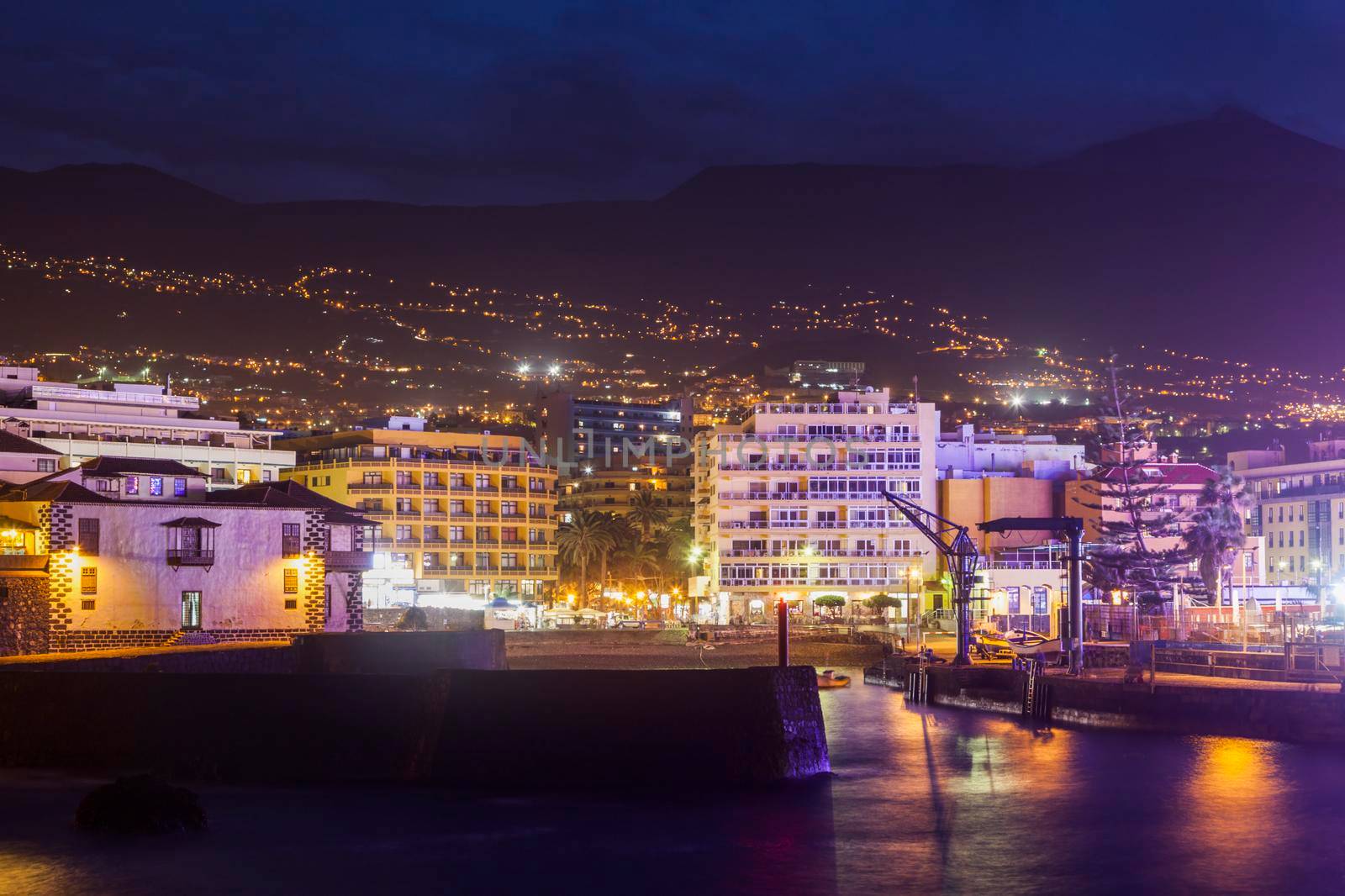 Puerto de la Cruz at night and Teide in the background Puerto de la Cruz, Tenerife, Canary Islands, Spain.
