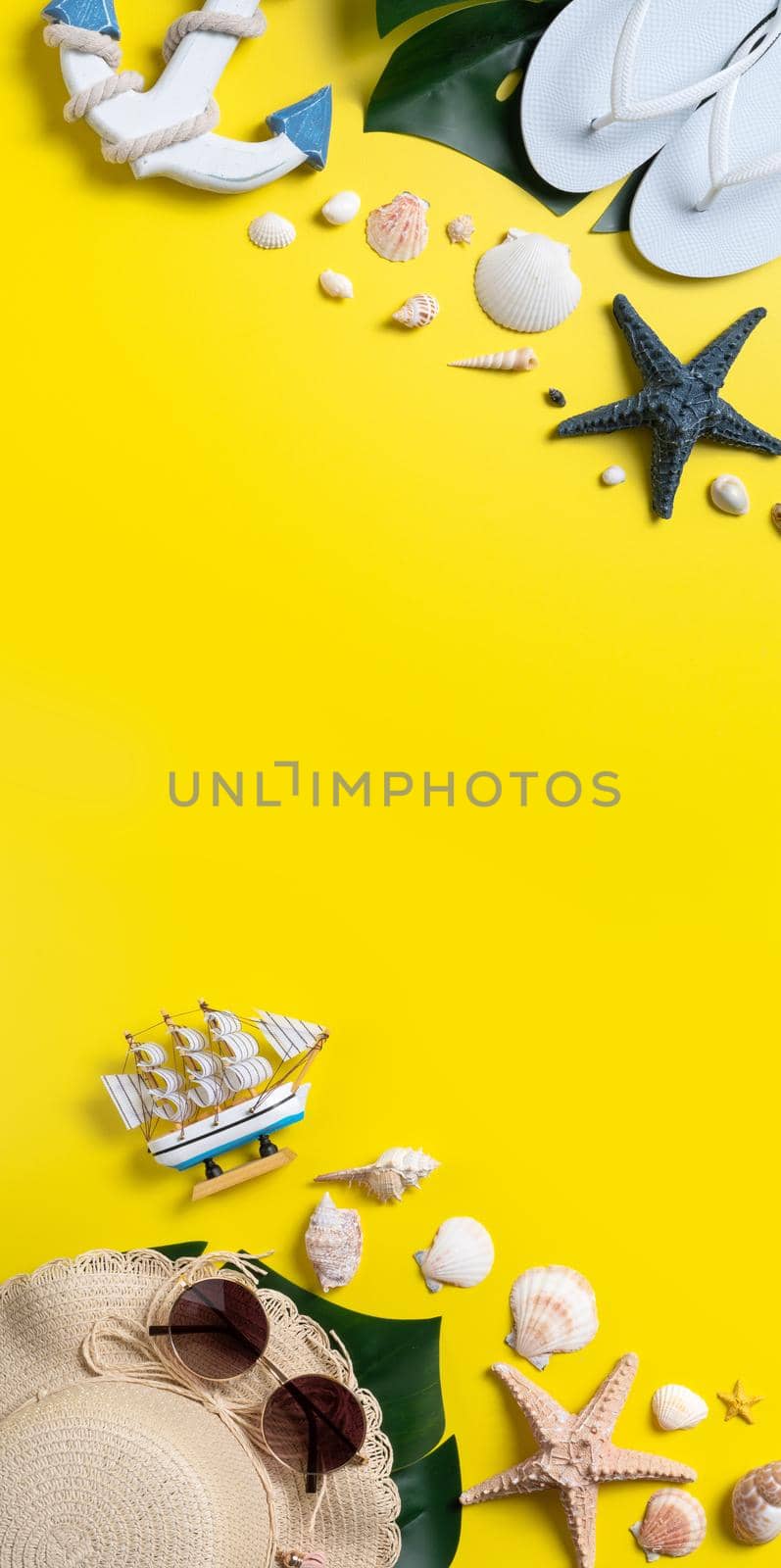 Summer beach design concept. Top view of holiday travel with shells, hat, slipper on yellow background.