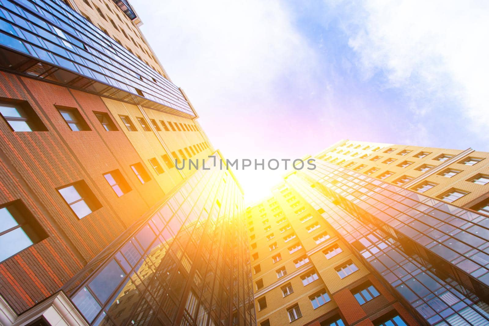 Windows of a high multi-storey residential building. Residential apartment building. Blue sky. Place under the text. Structure. An article about housing. Russia, St. Petersburg April 21, 2020