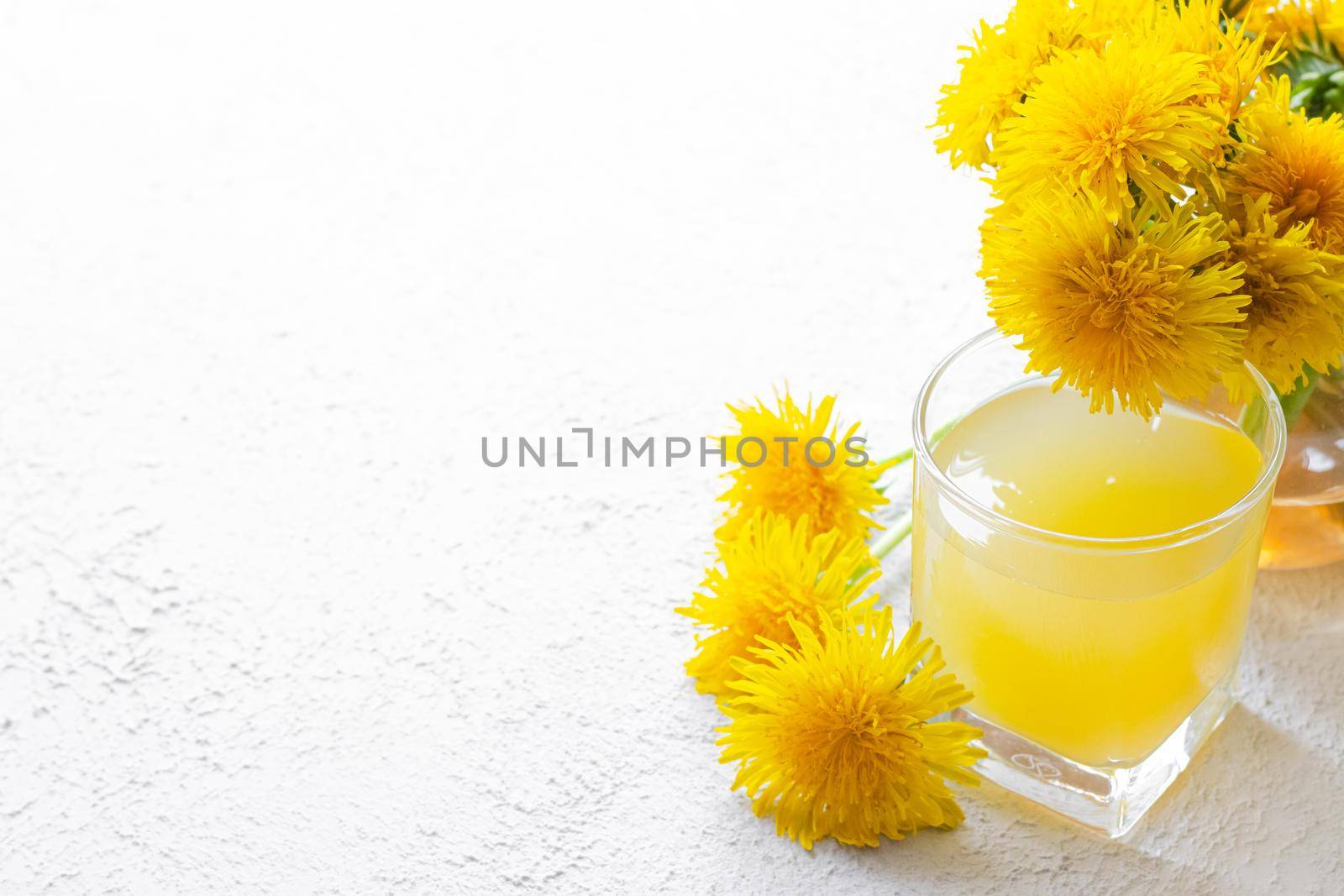 Dandelion tea. Yellow summer flowers dandelions. Tea party Homemade drink. Certified flower tea. Yellow drink. An article about teas. Hot drinks article