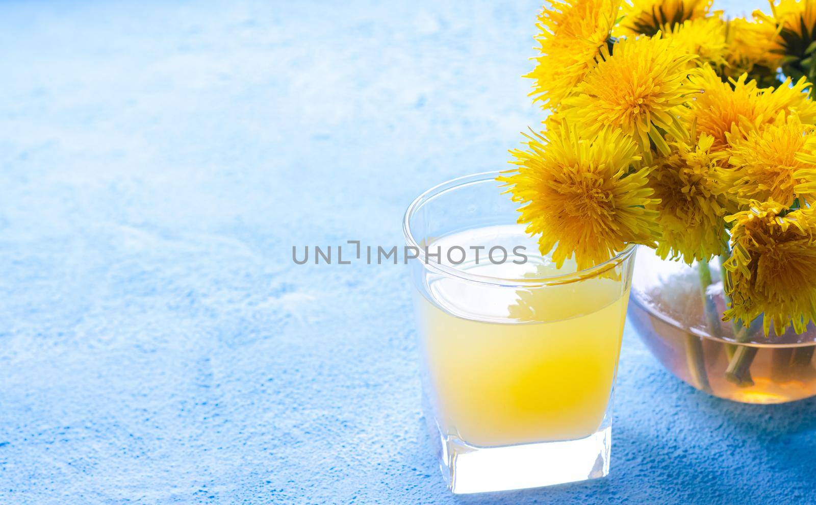 Dandelion tea. Yellow summer flowers dandelions. Tea party Homemade drink. Certified flower tea. Yellow drink. An article about teas. Hot drinks article