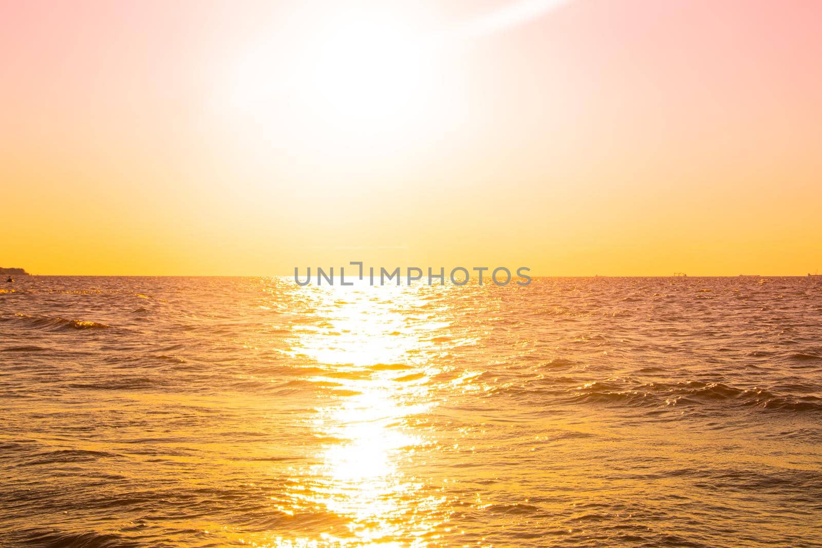 Sunset at sea. Warm sunny sunset over the sea. Sea waves. The sun sets over the horizon. The Gulf of Finland