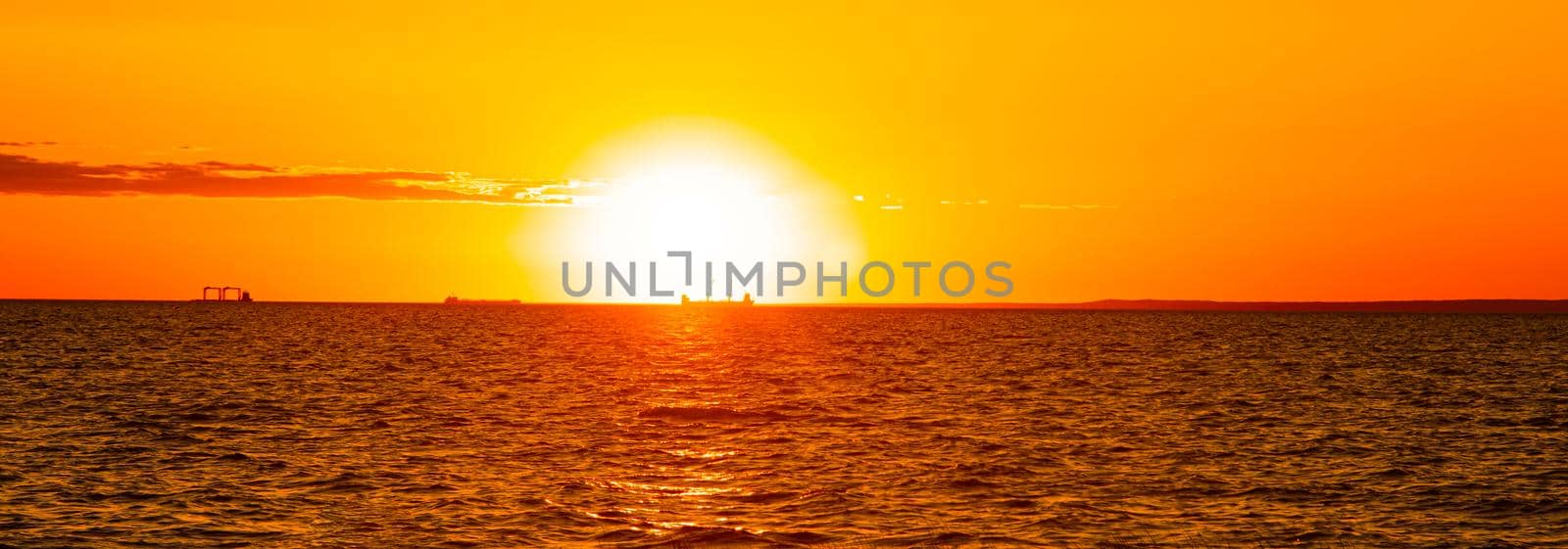 Sunset at sea. Warm sunny sunset over the sea. Sea waves. The sun sets over the horizon. by alenka2194