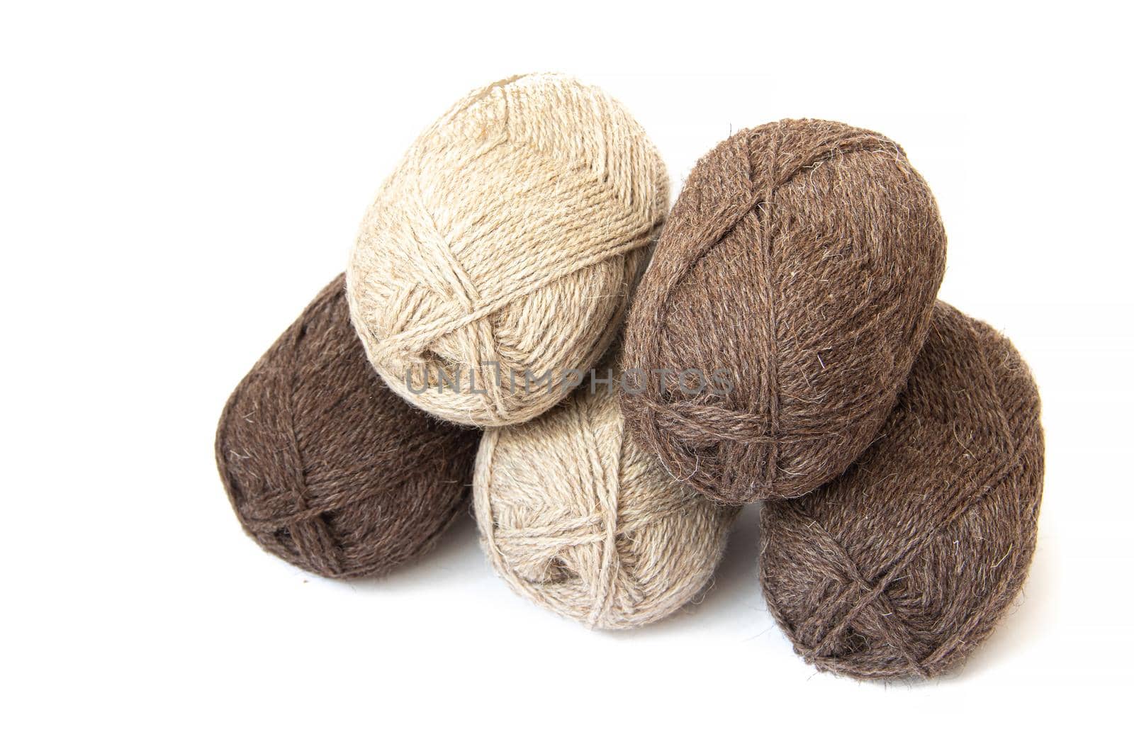 Wool yarns for knitting. Wool thread for knitting. Own hand. Knitting and needlework. Yarns for a scarf, sweater, and socks. Balls of yarn. Article about earning money at home with your hands. Article about knitting. Leisure for pensioners