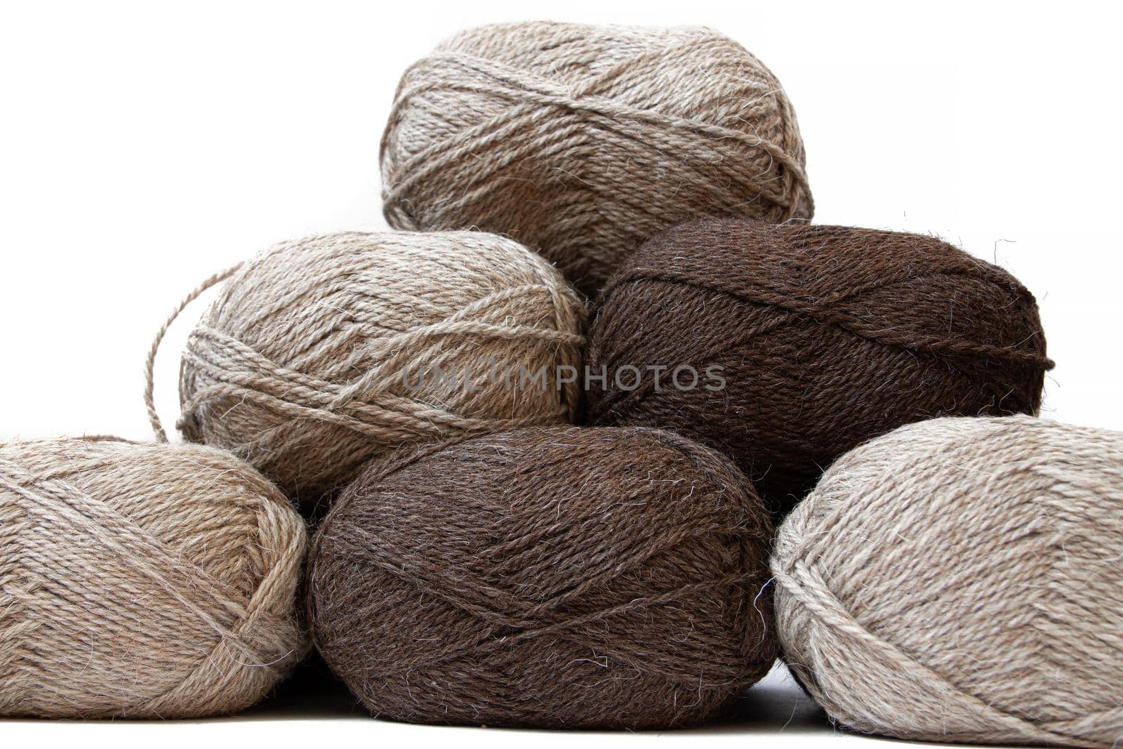 Wool yarns for knitting. Wool thread for knitting. Own hand. Knitting and needlework. Yarns for a scarf, sweater, and socks. Balls of yarn. Article about earning money at home with your hands. Article about knitting. Leisure for pensioners