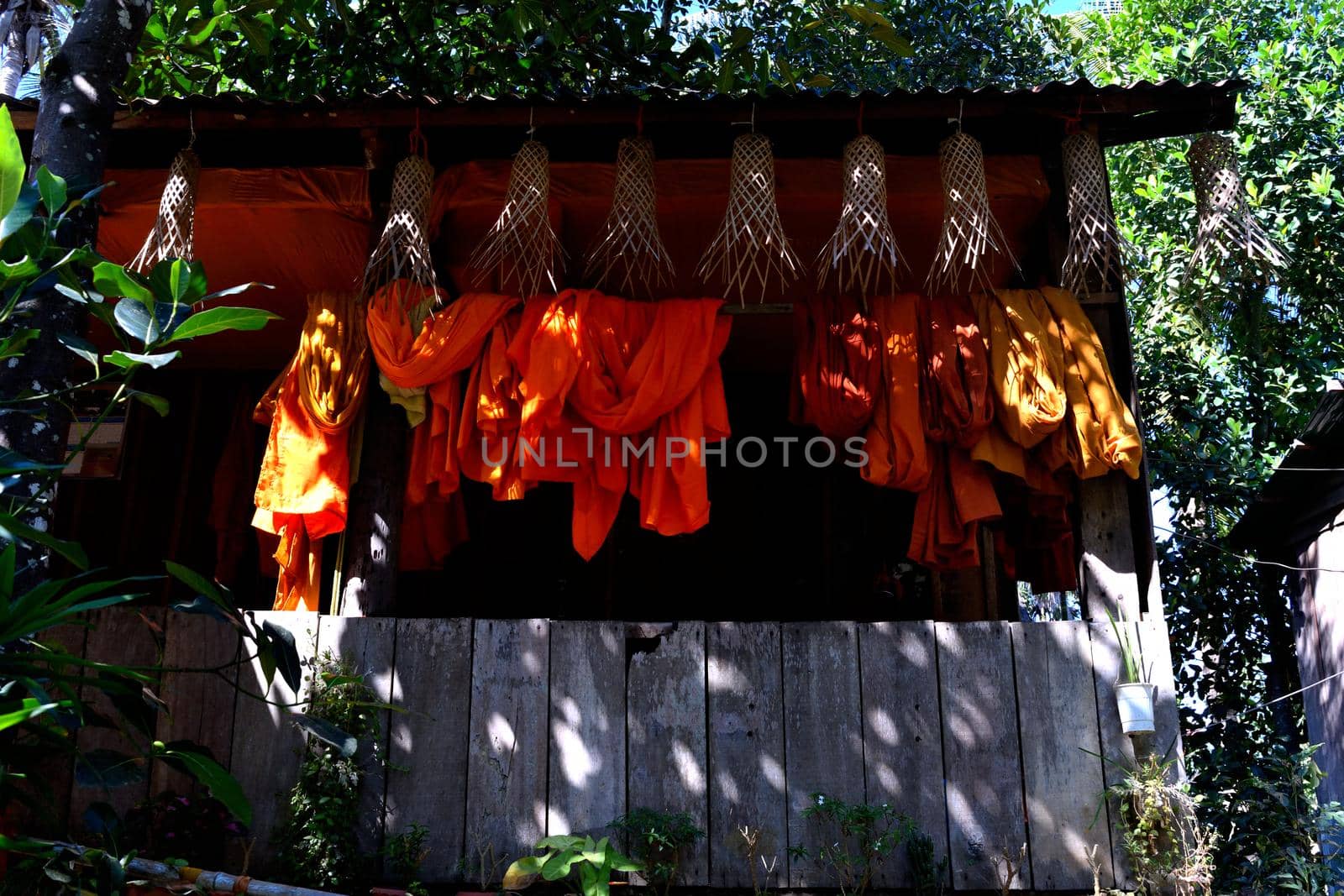 View of a hut and robes of Buddhist monks in the middle of the jungle