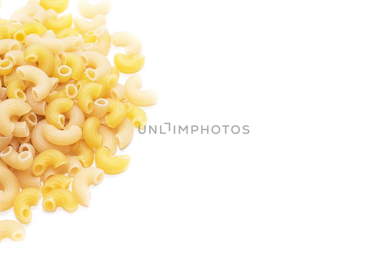 Macaroni horns isolated on a white background. Durum macaroni. Copy space. Article about pasta. Cooking pasta dishes
