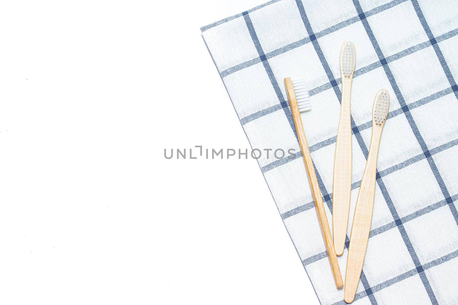 Bamboo toothbrush on a towel. Tooth cleaning. Article about choosing a toothbrush. Article about dental care. Bath accessories. Collection on vacation. The towel in the box. Natural material. Eco-products. No plastic surgery. Concern for the environment.