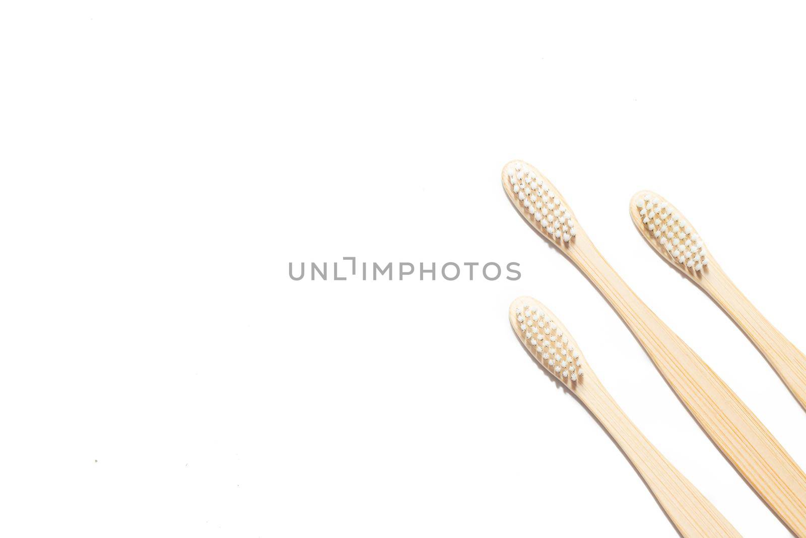 Bamboo toothbrush on an isolated background. Tooth cleaning. Article about choosing a toothbrush. Article about dental care. Bath accessories. Collection on vacation. Natural material. Eco-products. No plastic surgery. Concern for the environment. Copy space.