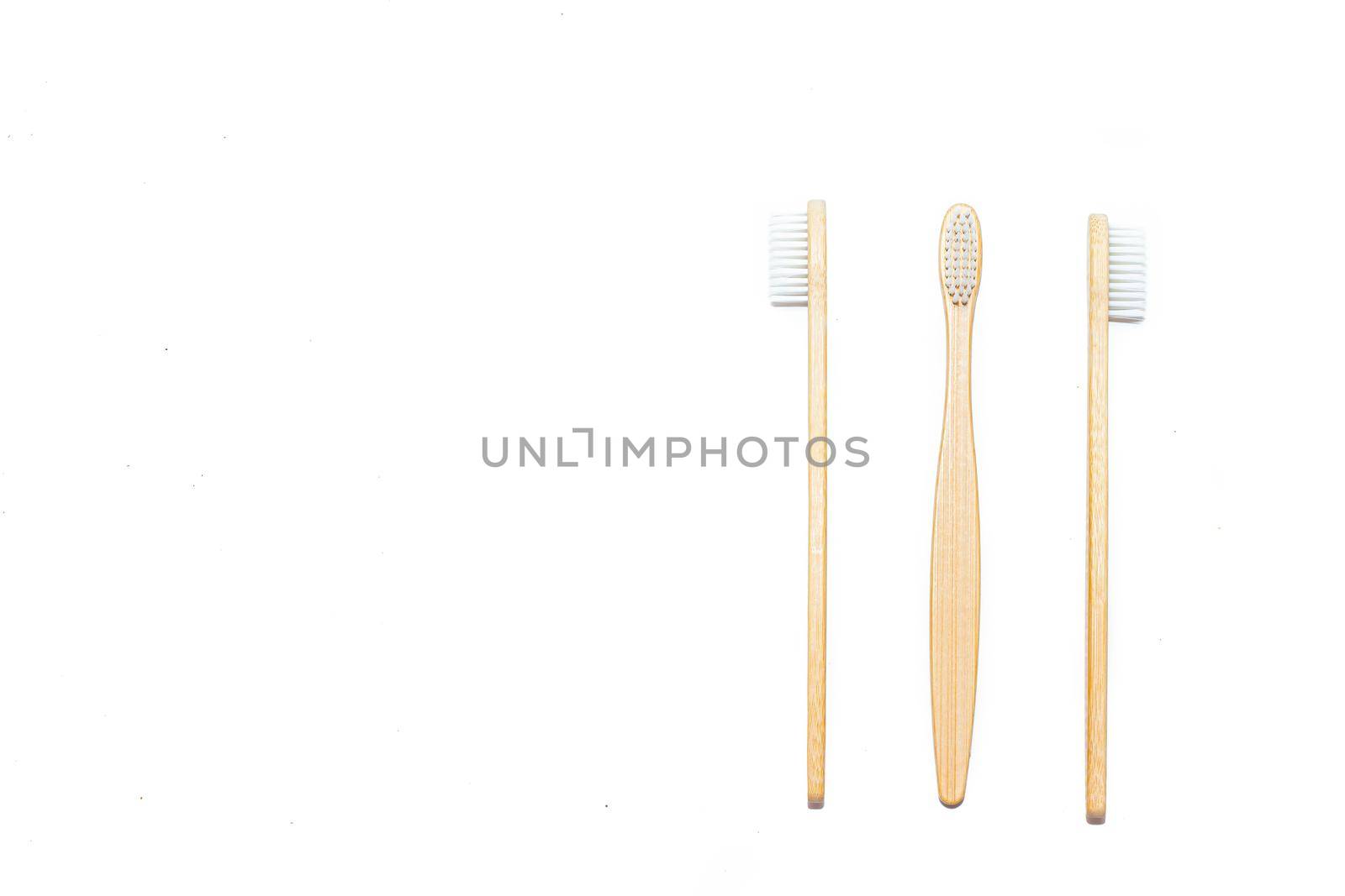Bamboo toothbrush on an isolated background. Tooth cleaning. Article about choosing a toothbrush. Article about dental care. Bath accessories. Collection on vacation. Natural material. Eco-products. No plastic surgery. Concern for the environment. Copy space.