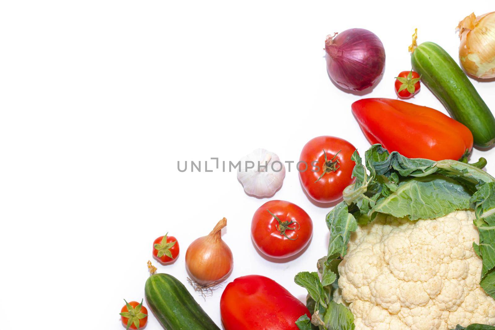 Vegetables layout on a white background . Home-grown vegetables. Harvest. Window dressing. Isolated vegetables. Article about vegetables. Agricultural industry. Copy space