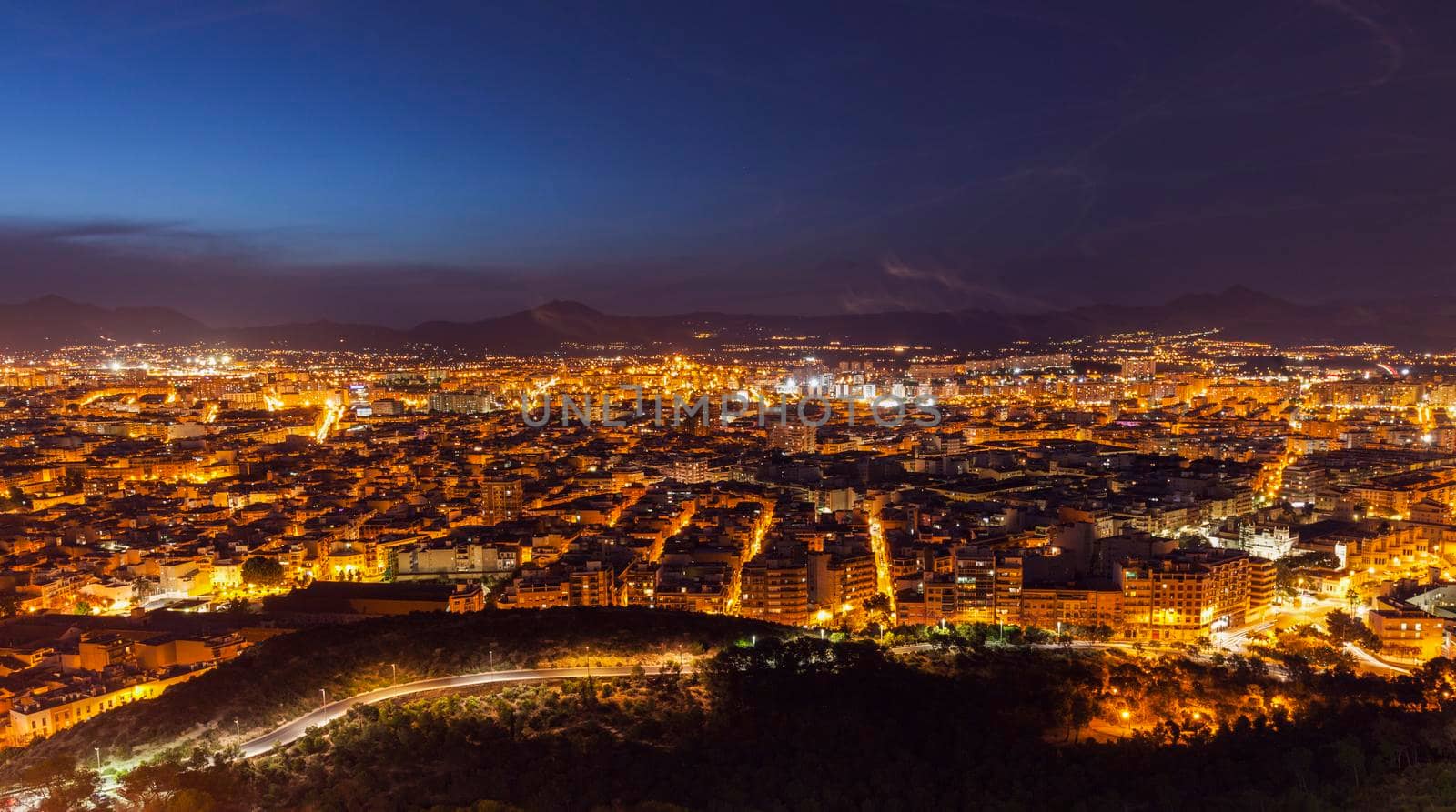 Aerial panorama of Alicante at night. Alicante, Valencian Community, Spain.