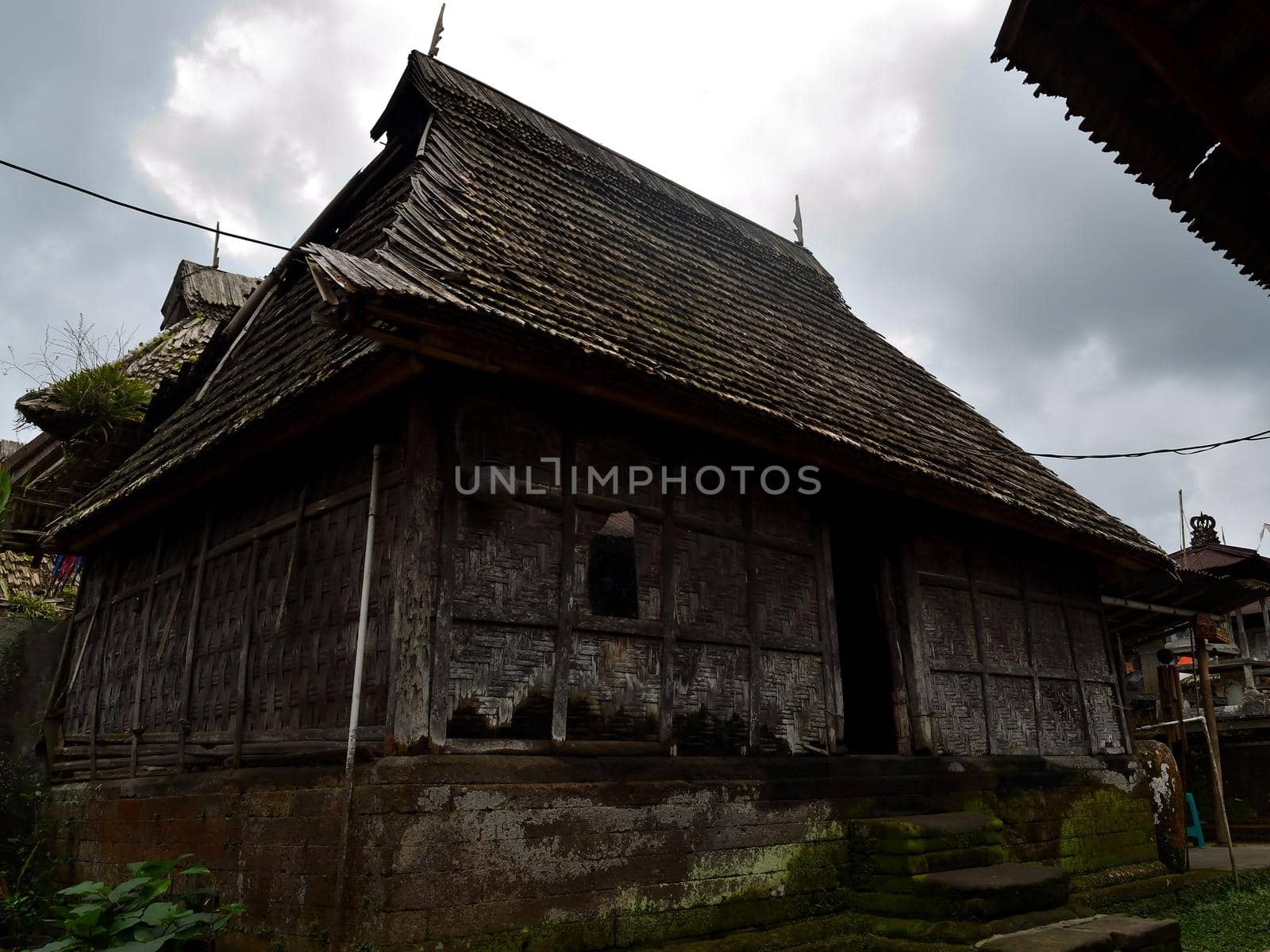 Penglipuran village in a cloudy day, Bali, Indonesia: the main street and its houses