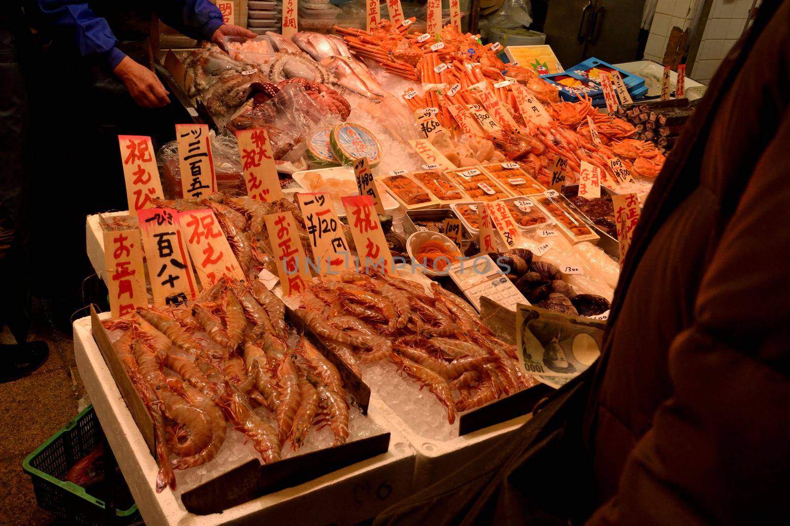 Closeup of a bench full of fish dish in a Japanese market by silentstock639