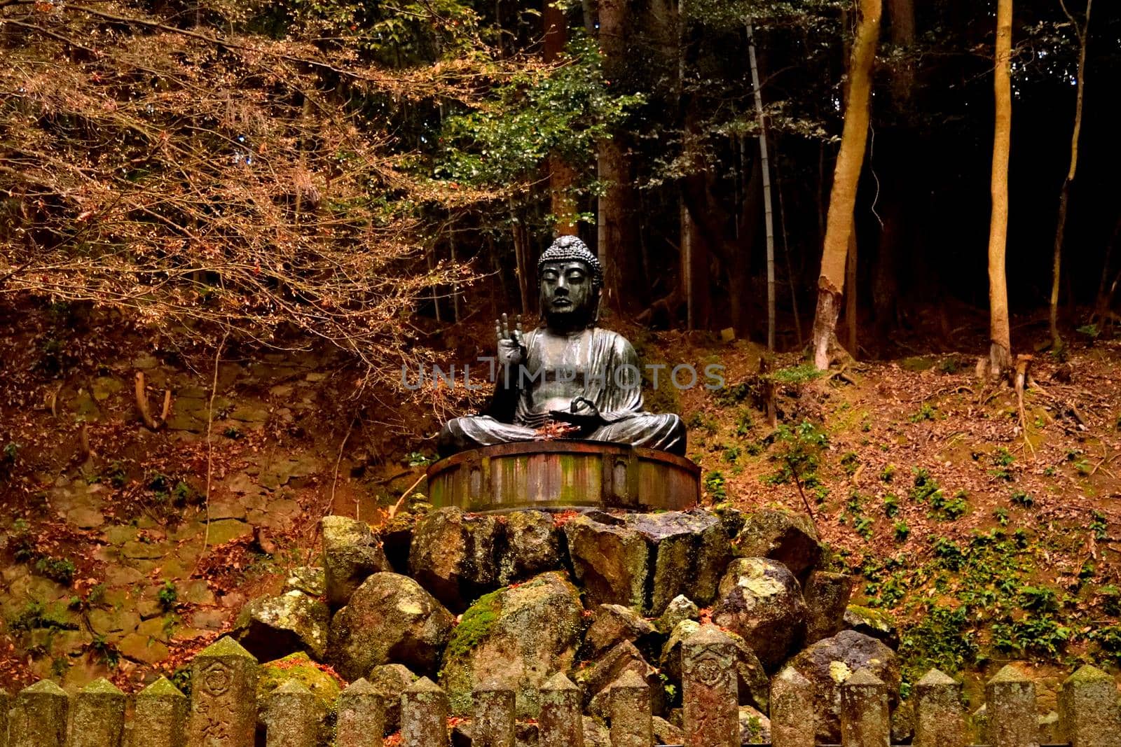 Closeup of a statue in the forest on the mt. Shosha by silentstock639