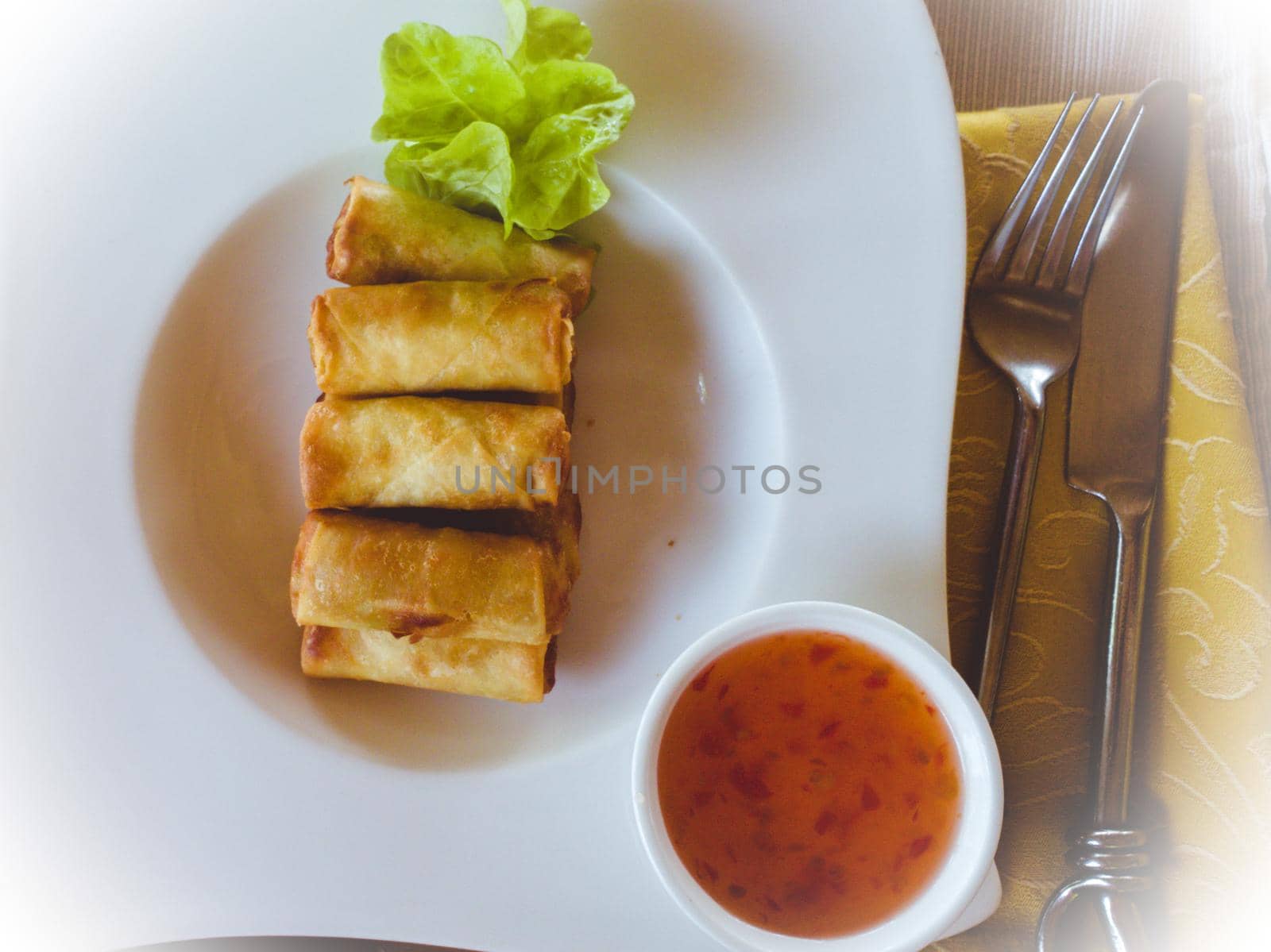 Delicious dish of vegetarian spring rolls with sauce by silentstock639