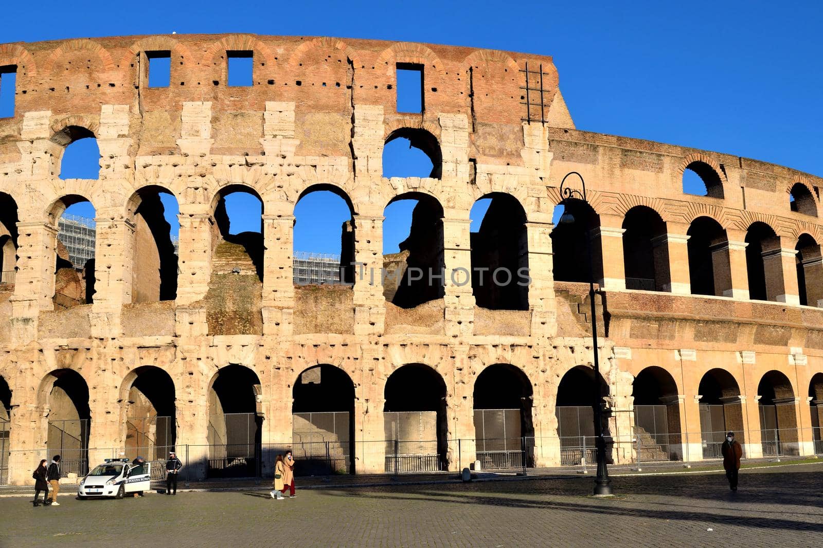 Rome, Italy - December 13th 2020: View of the Coliseum with few tourists due to the Covid19 epidemic