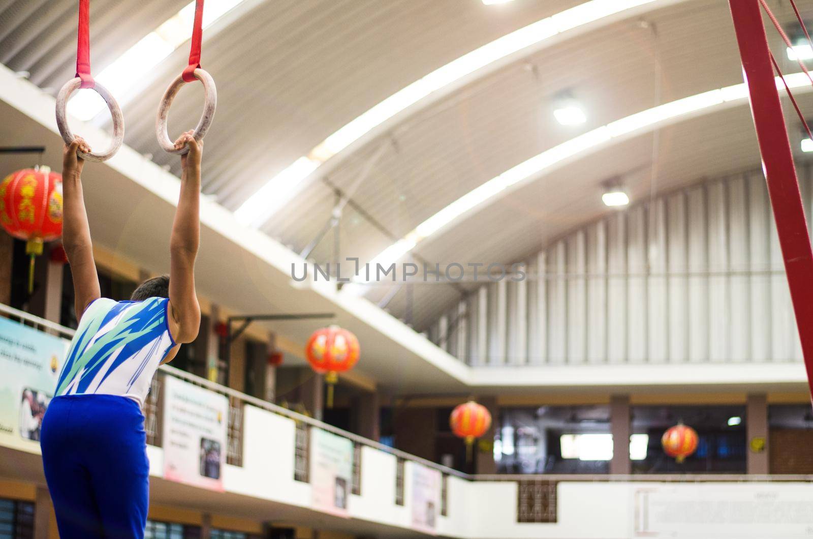 Portrait of little kid gymnast in a championship.