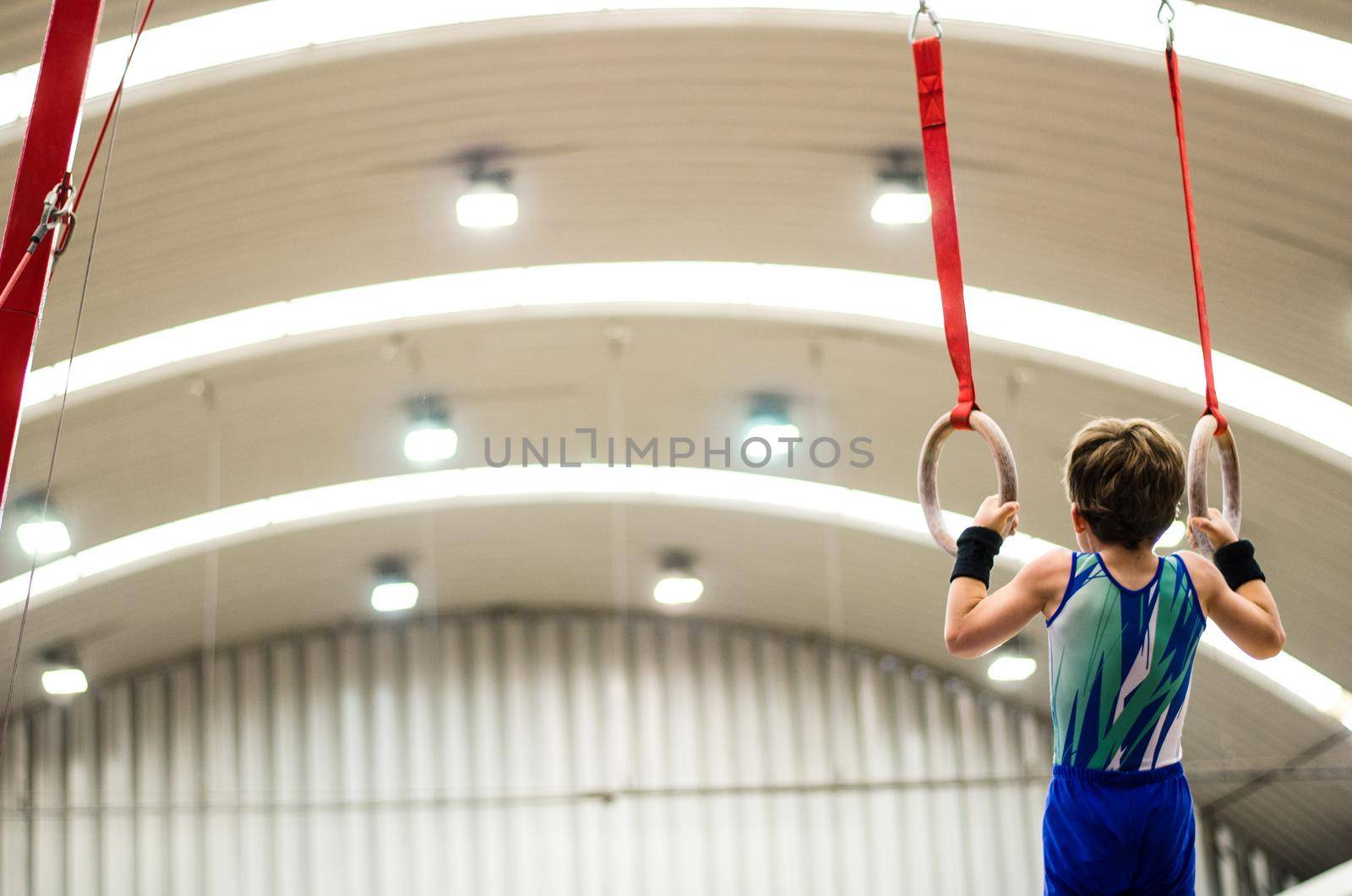 Portrait of little kid gymnast in a championship.