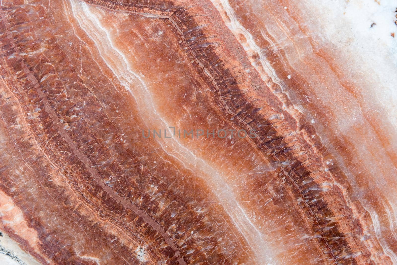Smooth surface texture of stone, White and red line color striped wave pattern of marble, Strong structure durable nature of rock for abstract background