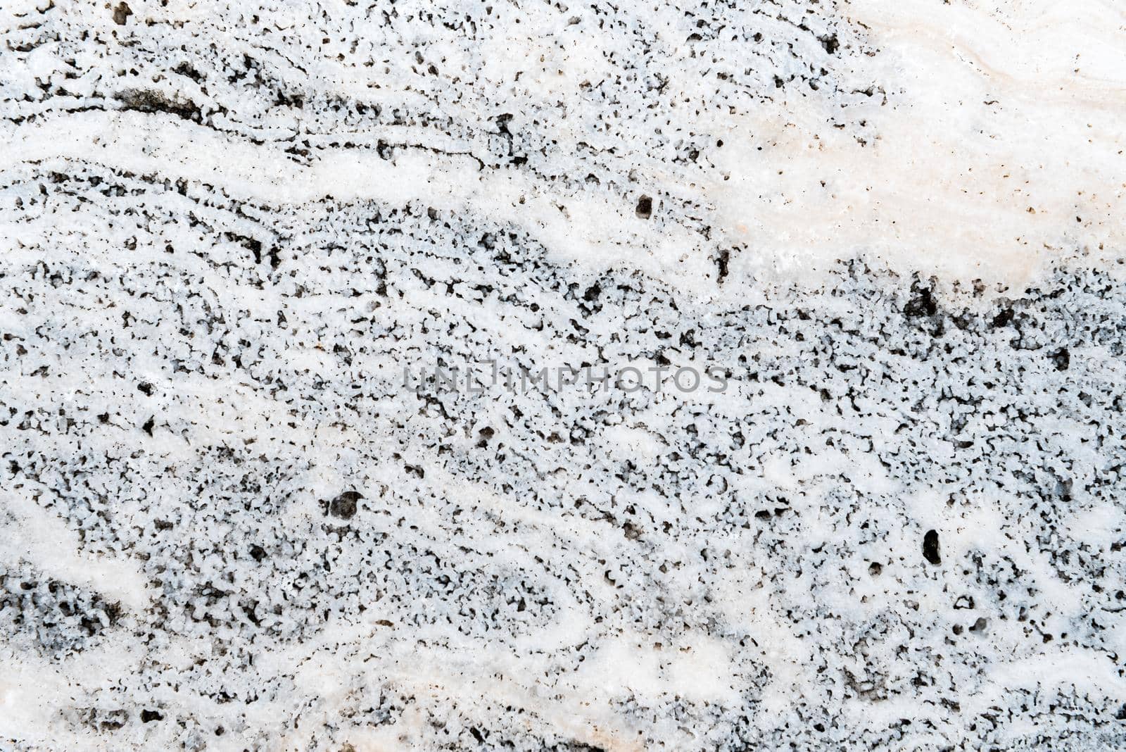 Smooth surface texture of stone, White and black color striped wave pattern of marble, Strong structure durable nature of rock for abstract background