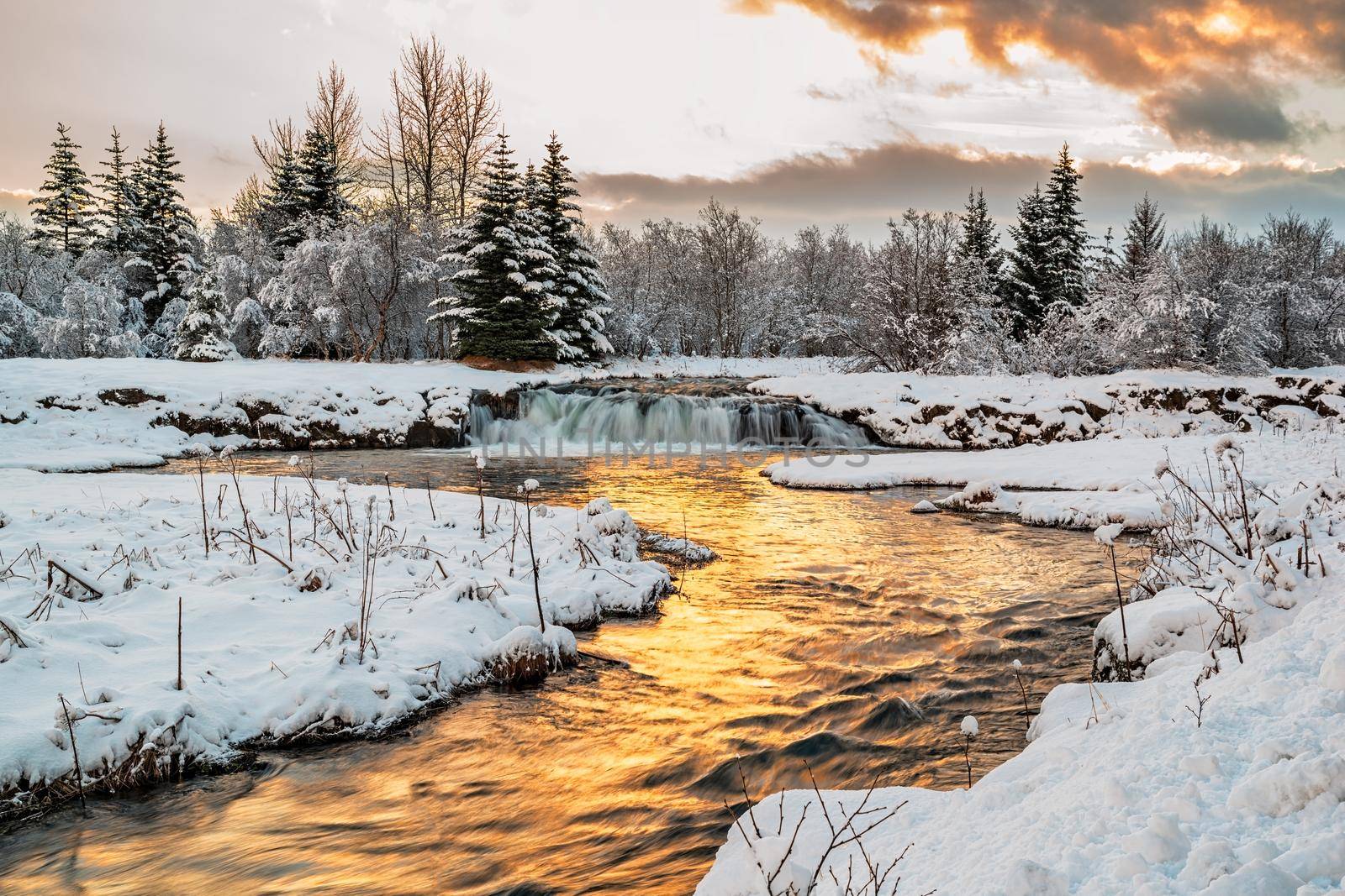 Winter in Ellidaardalur at sunrise along the river and waterfall, Iceland