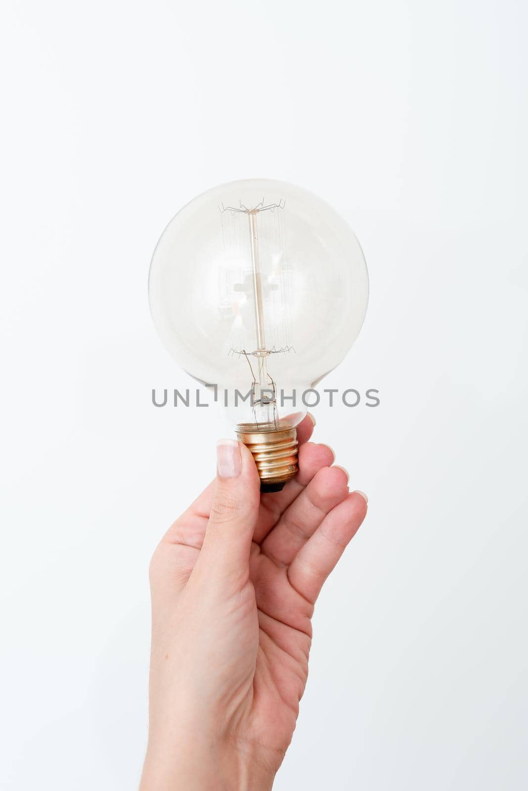 Woman Holding Lamp Presenting New Ideas For Project, Man Hand Showing Bulb And New Technologies, Hand Holding Lighbulb Displaying New Idea by nialowwa