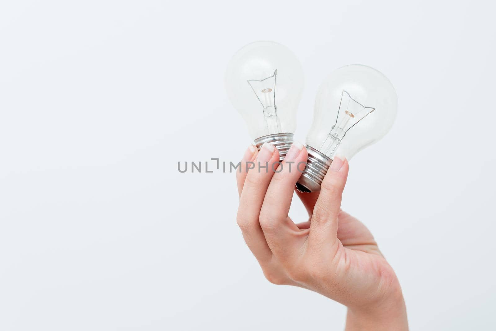 Woman Hands Holding Lamp Presenting Ideas For Project, Man Palm Showing Bulbs And New Technologies, Two Held Lightbulbs Exhibiting Another Opinion.