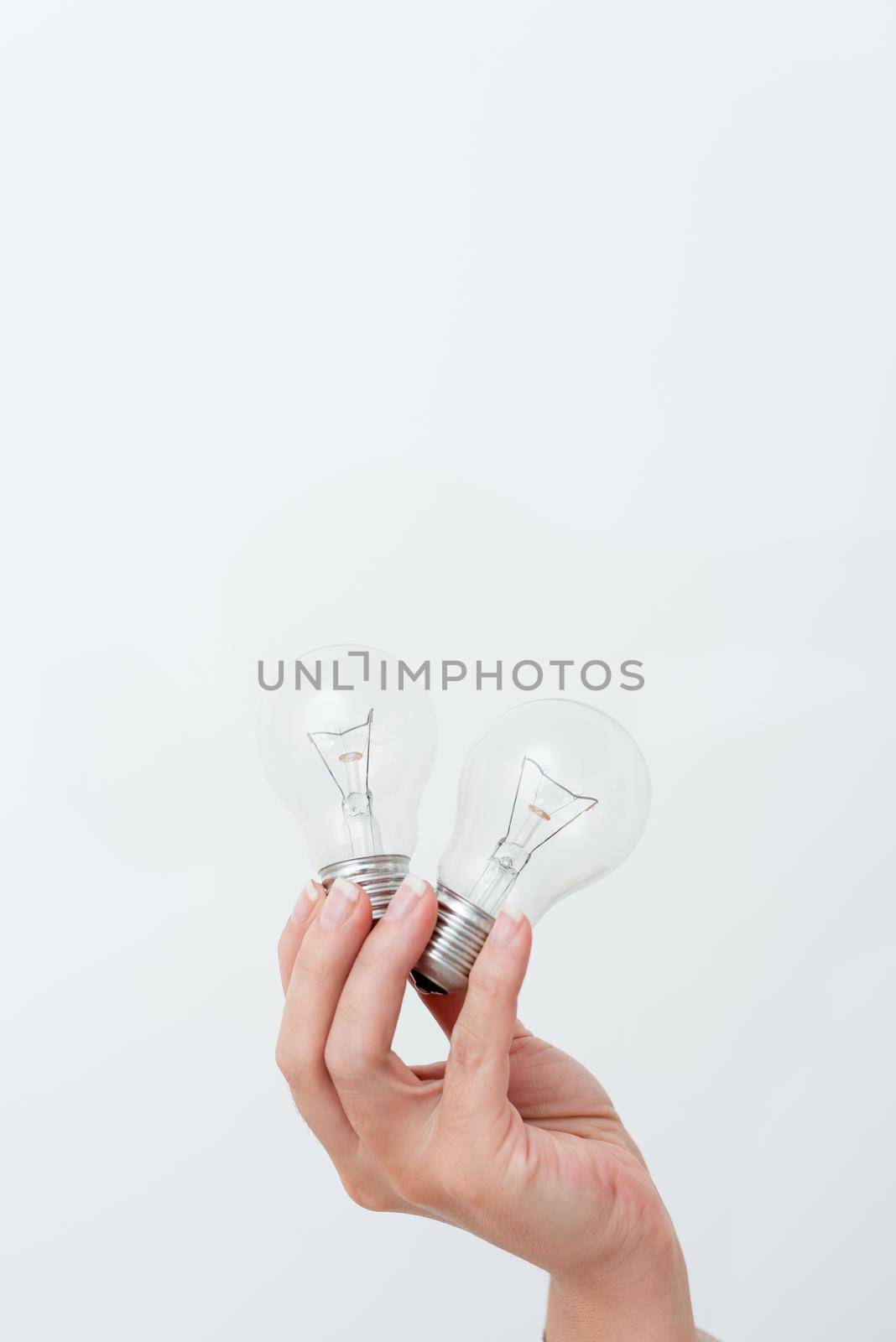 Woman Hands Holding Lamp Presenting Ideas For Project, Man Palm Showing Bulbs And New Technologies, Two Held Lightbulbs Exhibiting Another Opinion by nialowwa
