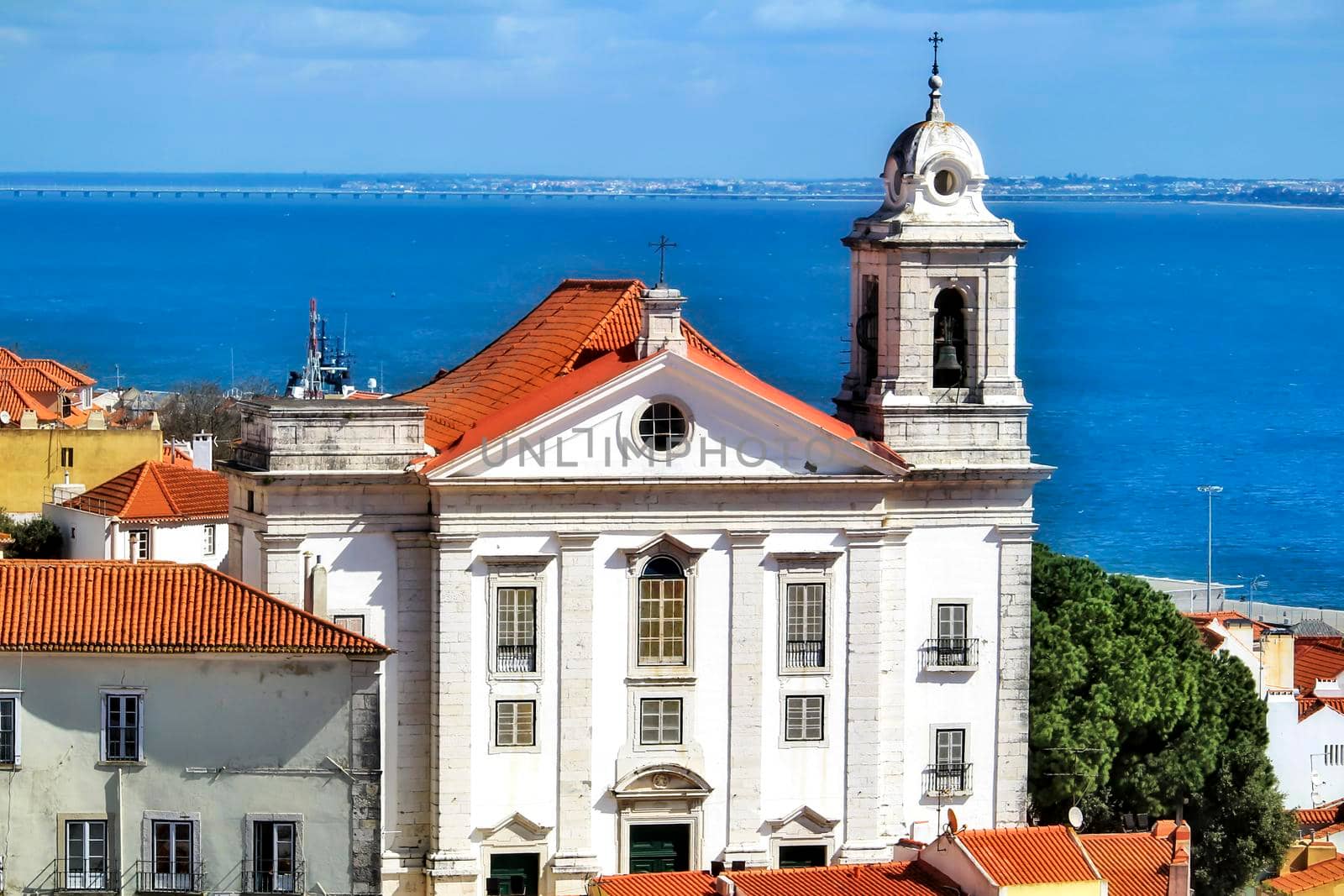 Beautiful Saint Stephen view from the viewpoint of Santa Luzia in Lisbon. The Tagus river in the background on a sunny day