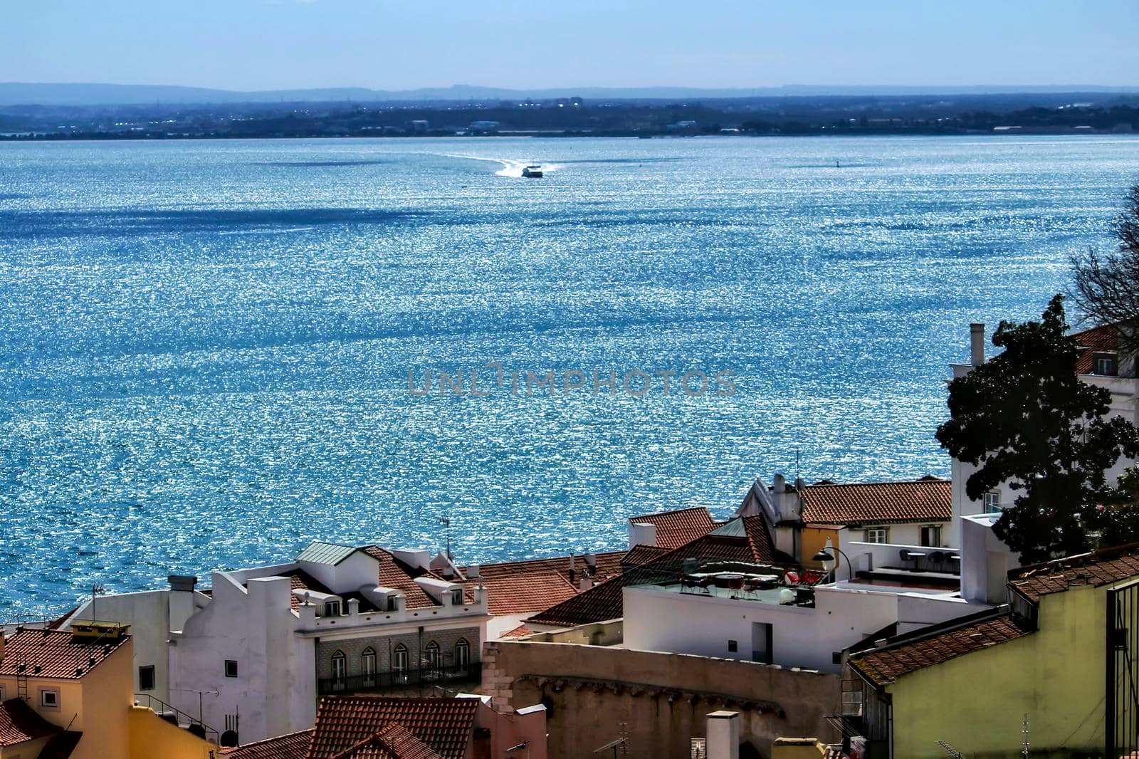 Beautiful panoramic view of Alfama neighborhood from the viewpoint of Santa Lucia in Lisbon on a sunny day