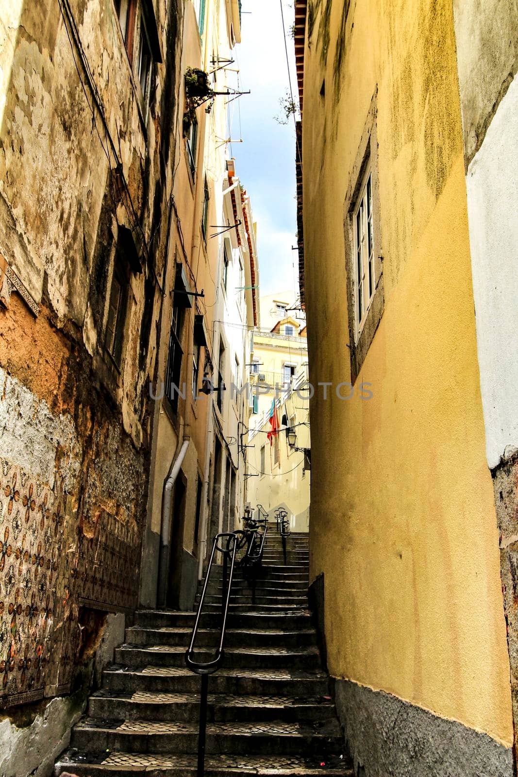Old colorful and beautiful facades with vintage streetlight in Lisbon streets in Spring.