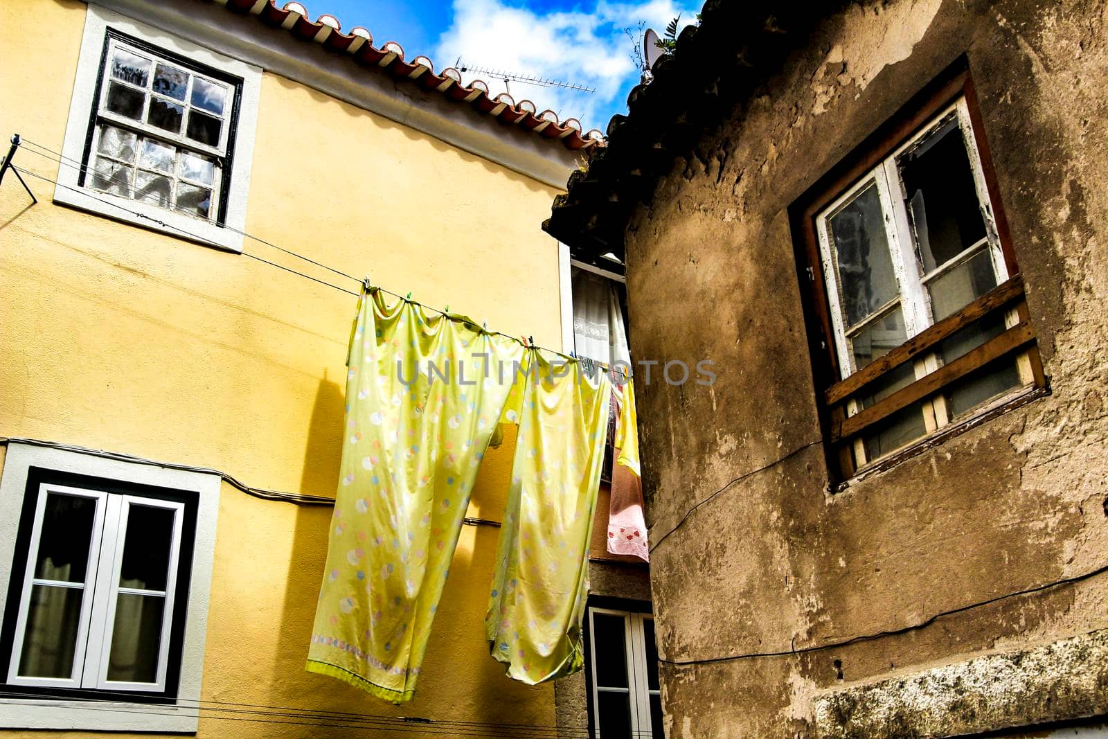 Old colorful and beautiful facades with vintage streetlight in Lisbon streets in Spring.