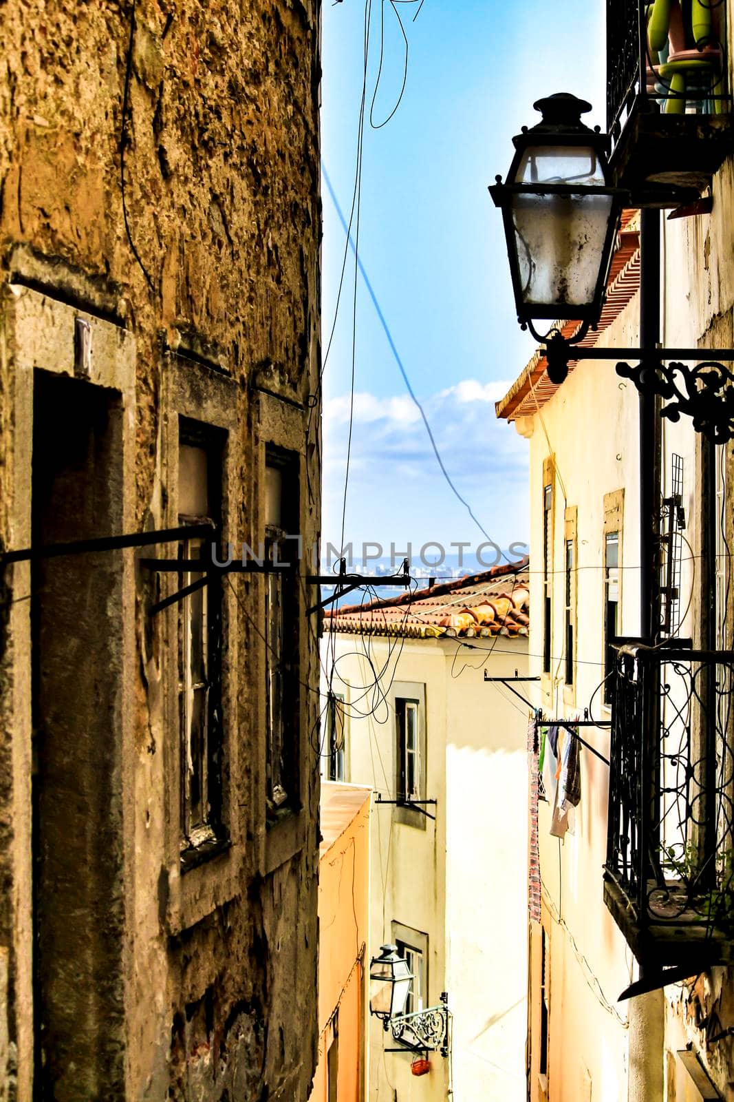 Old colorful and beautiful facades with vintage streetlight in Lisbon streets in Spring.
