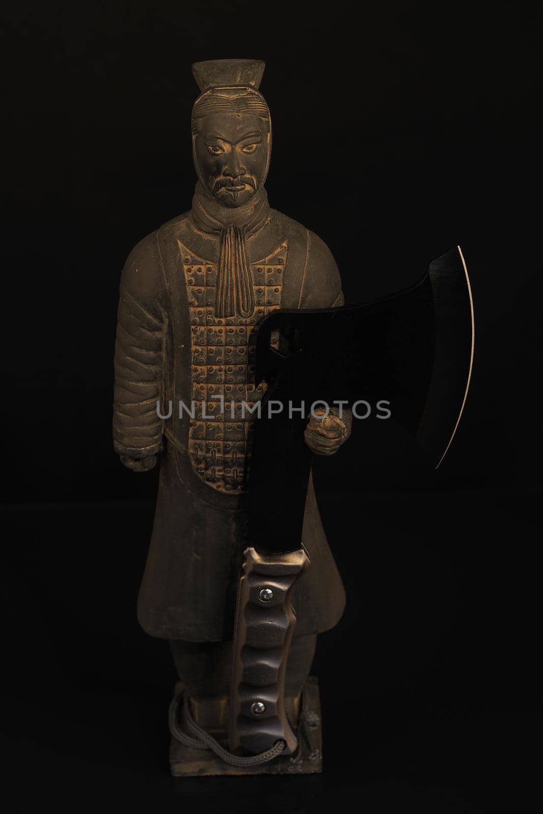A Chinese soldier. A figurine or a statuette of a Chinese warrior with an axe. High quality photo