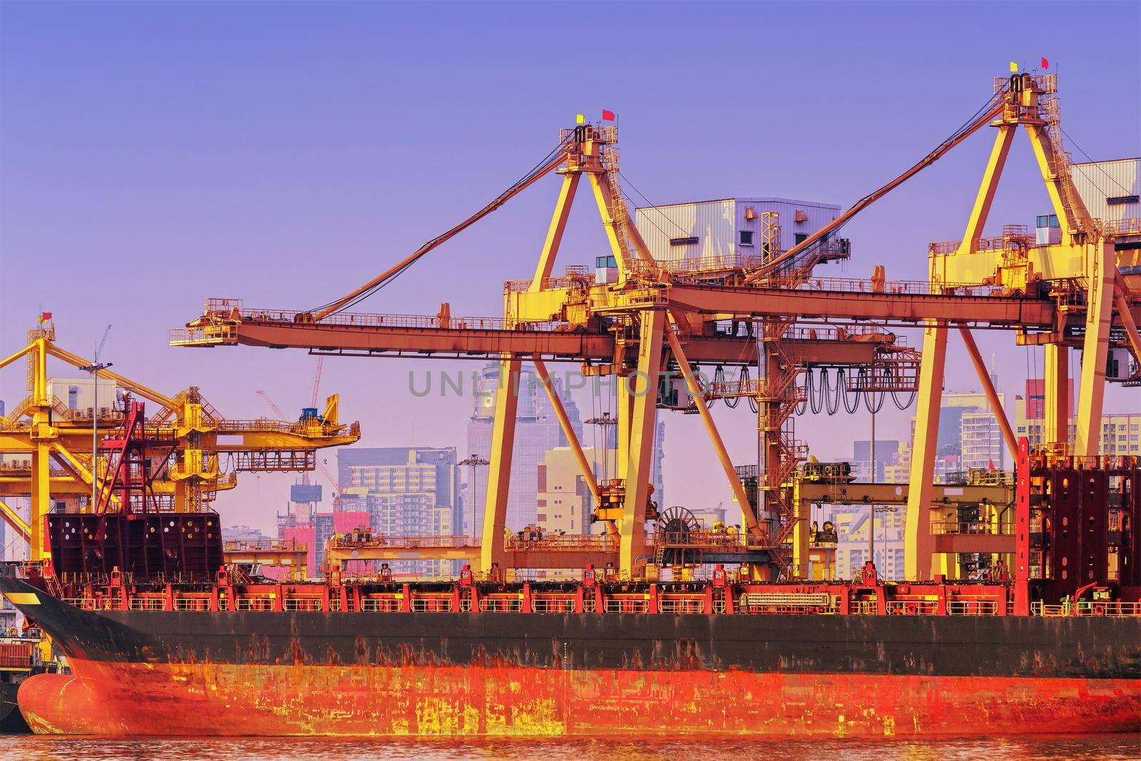 Container ship in export and import business and logistics. Shipping cargo to harbor by crane. Water transport International.