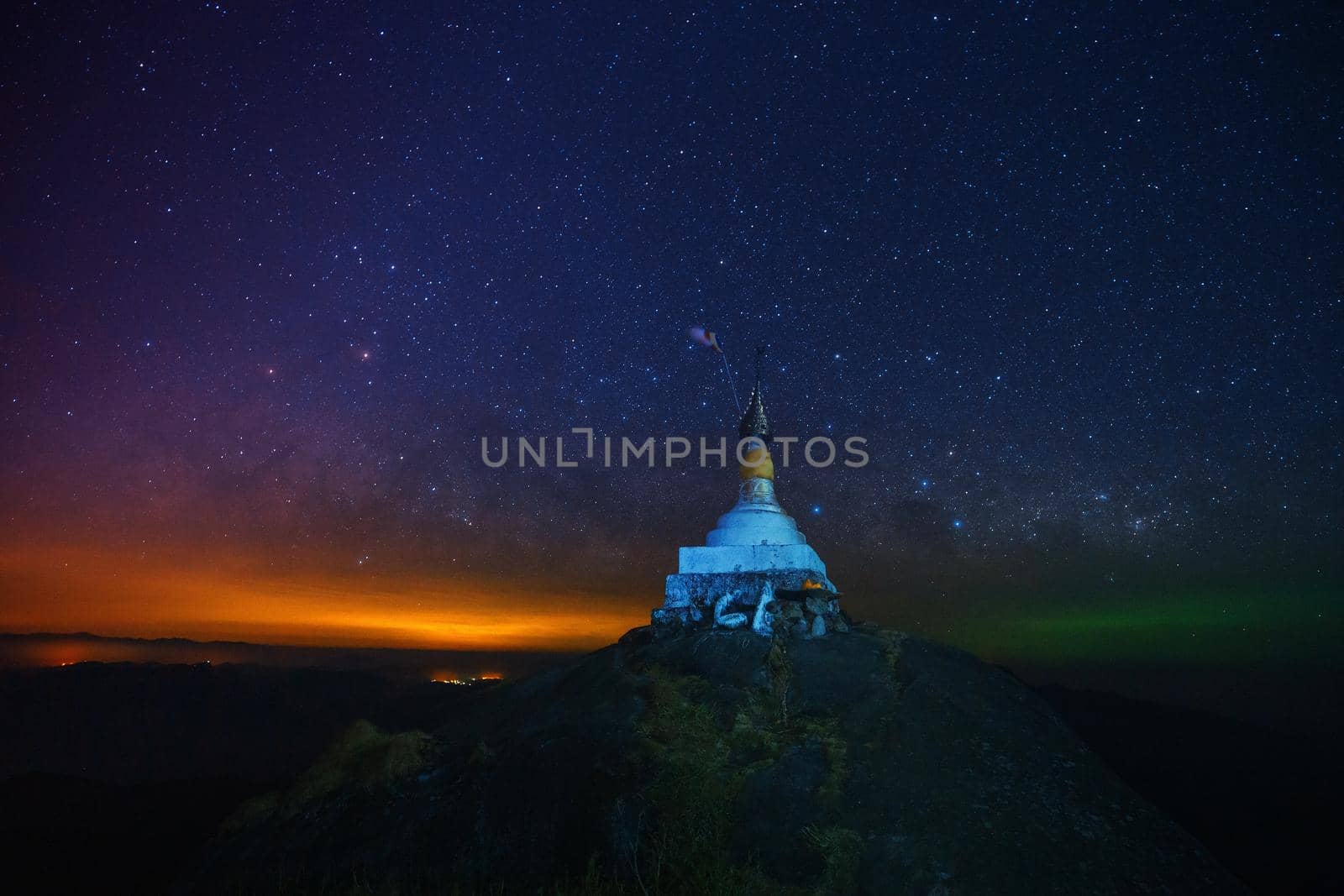 A pagoda on the top of the hill at night With a background full of stars