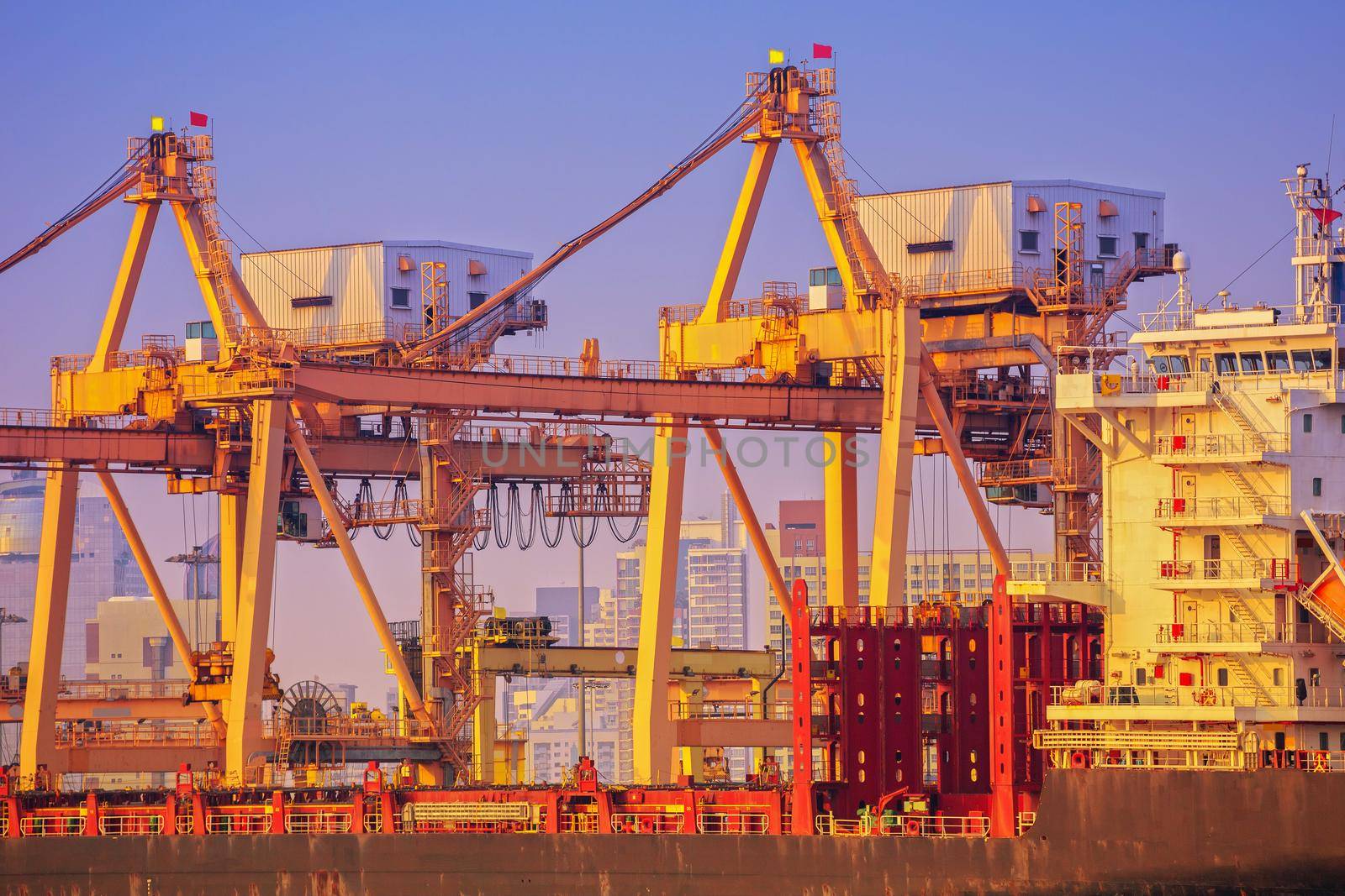 Container ship in export and import business and logistics. Shipping cargo to harbor by crane. Water transport International.