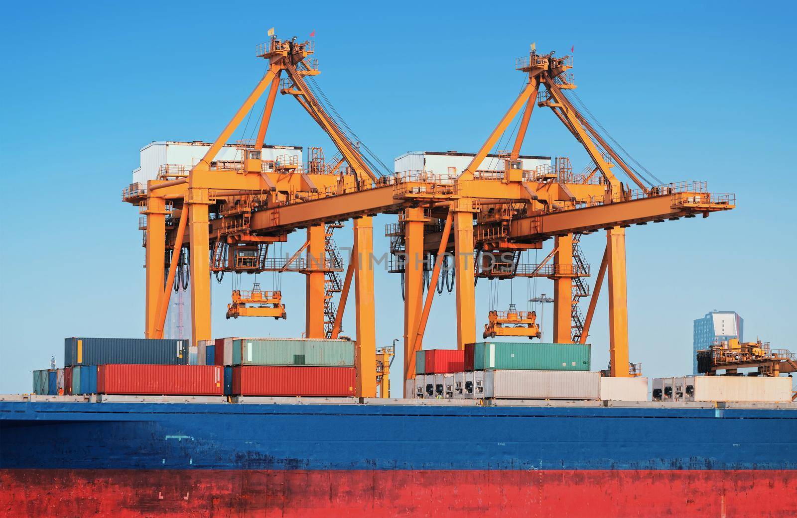 Container ship in export and import business and logistics. Shipping cargo to harbor by crane. Water transport International.