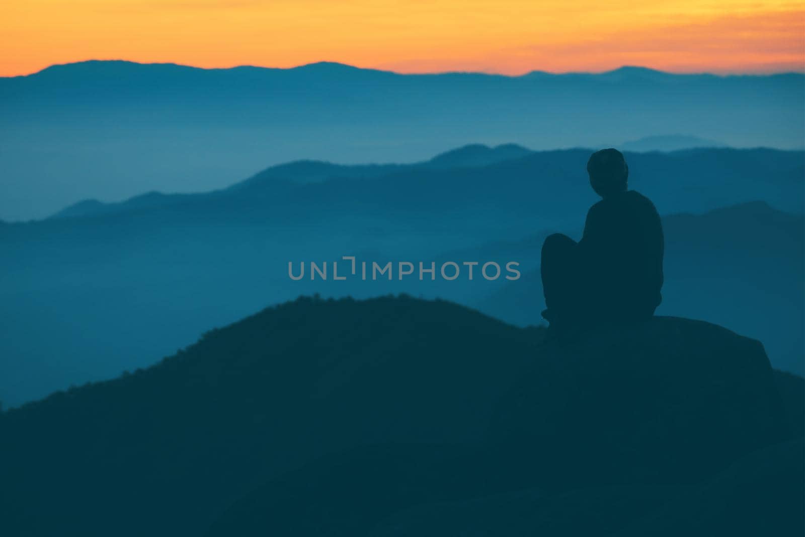People sitting and watching the sunrise in the morning