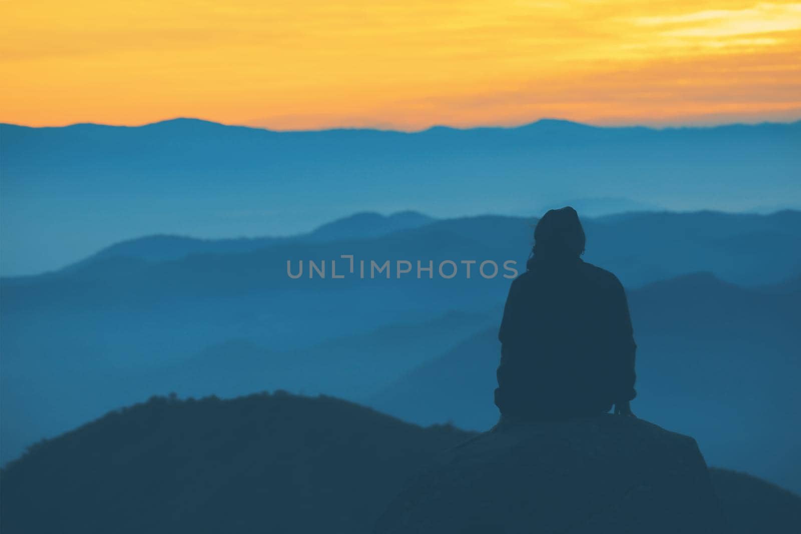 People sitting and watching the sunrise in the morning