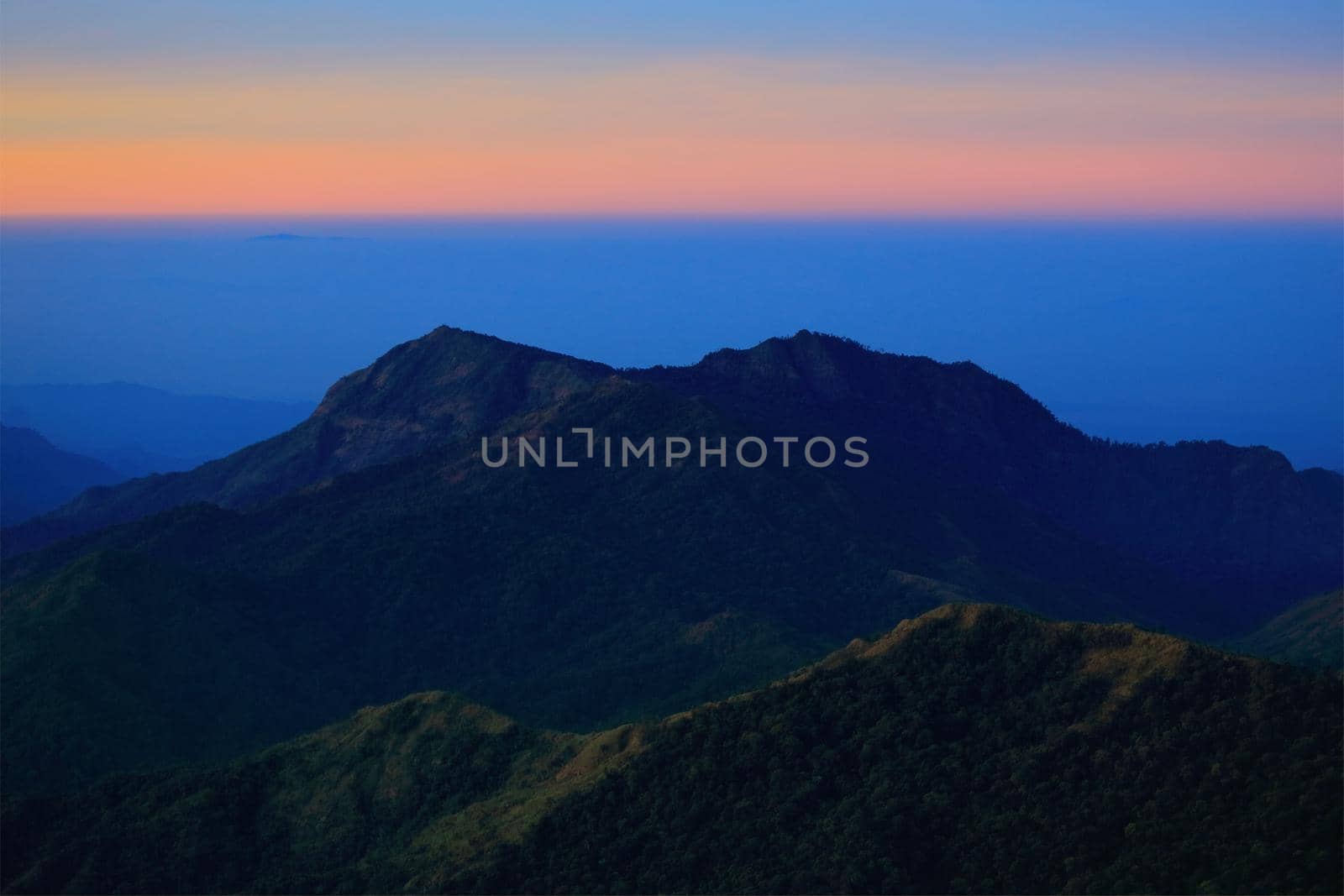 Mountain view in the morning. The background is orange sky.