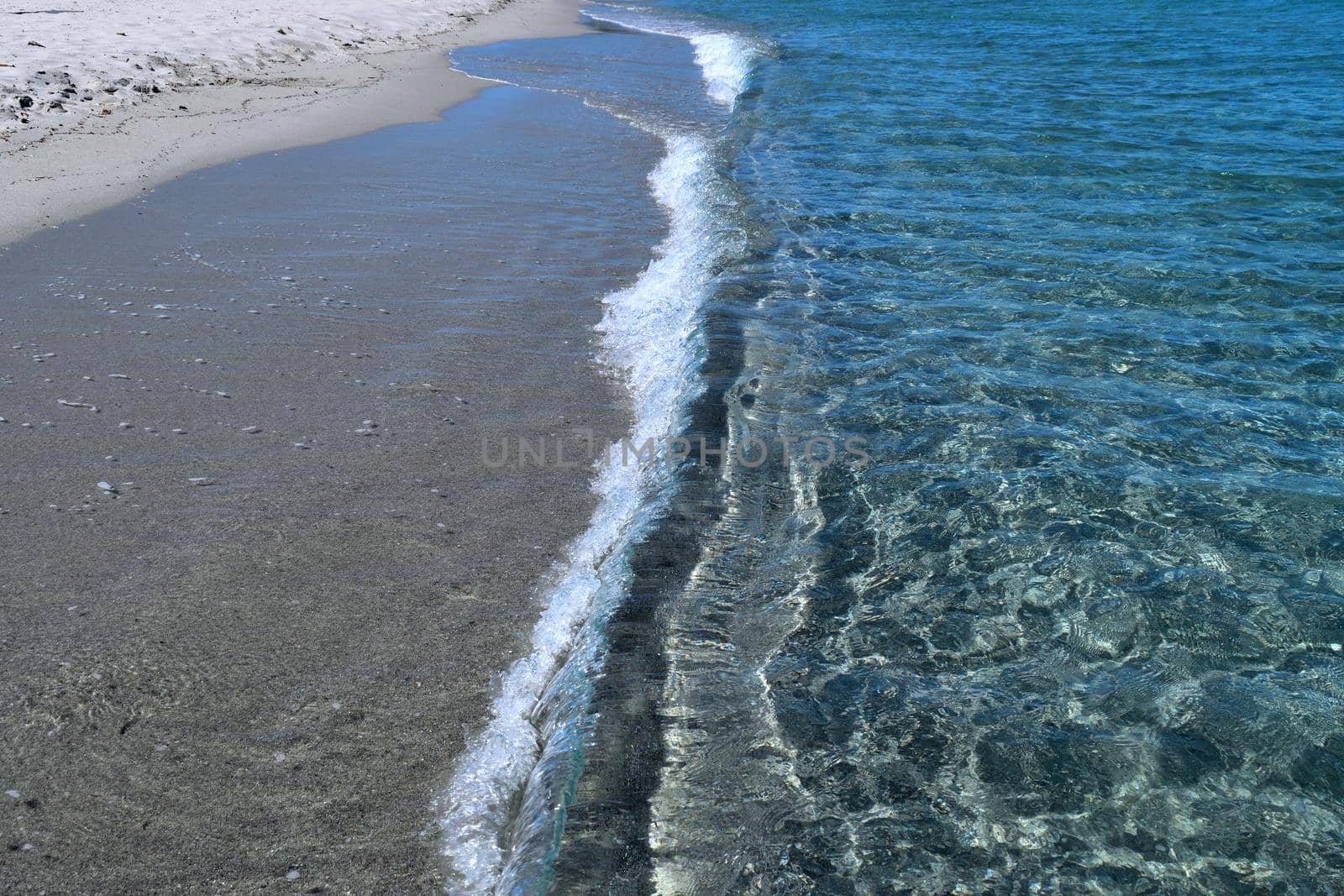 Closeup of the clear waters and white sand in Costa Smeralda, Sardinia, Italy by silentstock639