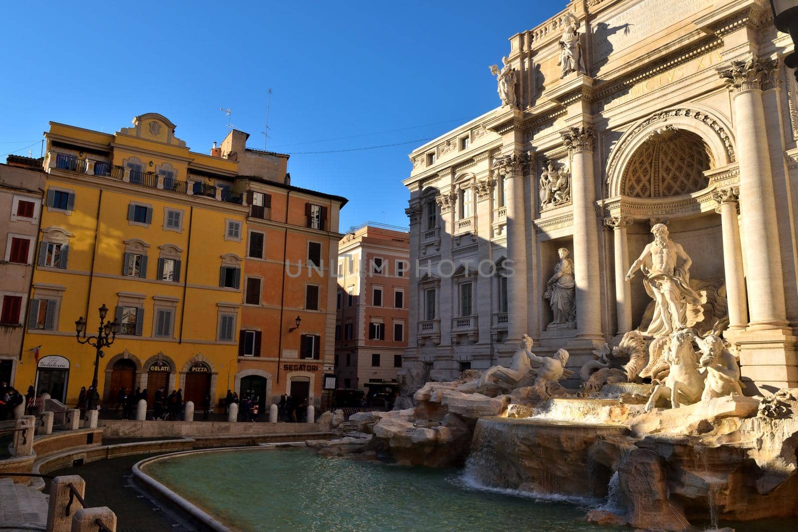 Rome, Italy - December 13th: View of the Trevi fountain with few tourists due to the Covid19 epidemic. by silentstock639