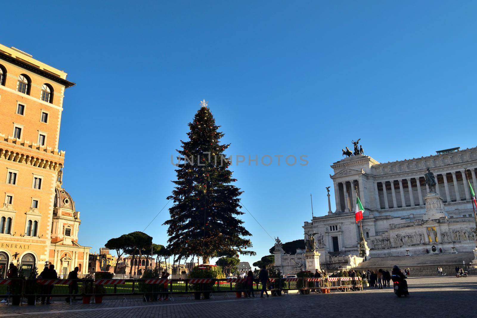 Rome, Italy - December 13th 2020: View of the famous Christmas tree in Piazza Venezia with few tourists due to the Covid19 epidemic. by silentstock639